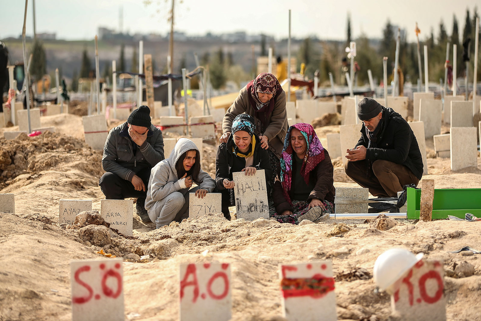People mourn at a cemetery where they bury their loved ones who died in Monday's earthquake, in Adiyaman, Turkey, on Friday, February 10.