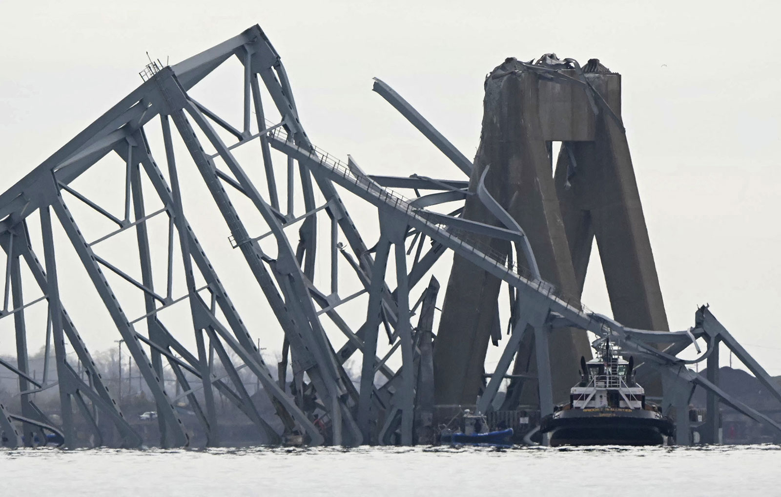 The steel frame of the Francis Scott Key Bridge lies in the water after it collapsed in Baltimore on Tuesday.
