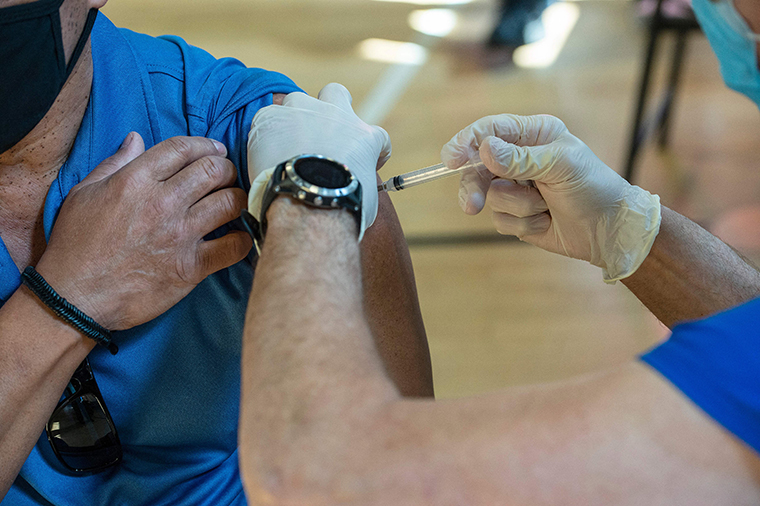 A nurse inoculates a person with the second Moderna Covid-19 vaccine dose at a mobile Covid-19 vaccination clinic at Saint Charles Borromeo Catholic Church's McGivney community center in Bridgeport, Connecticut on April 20, 2021. 