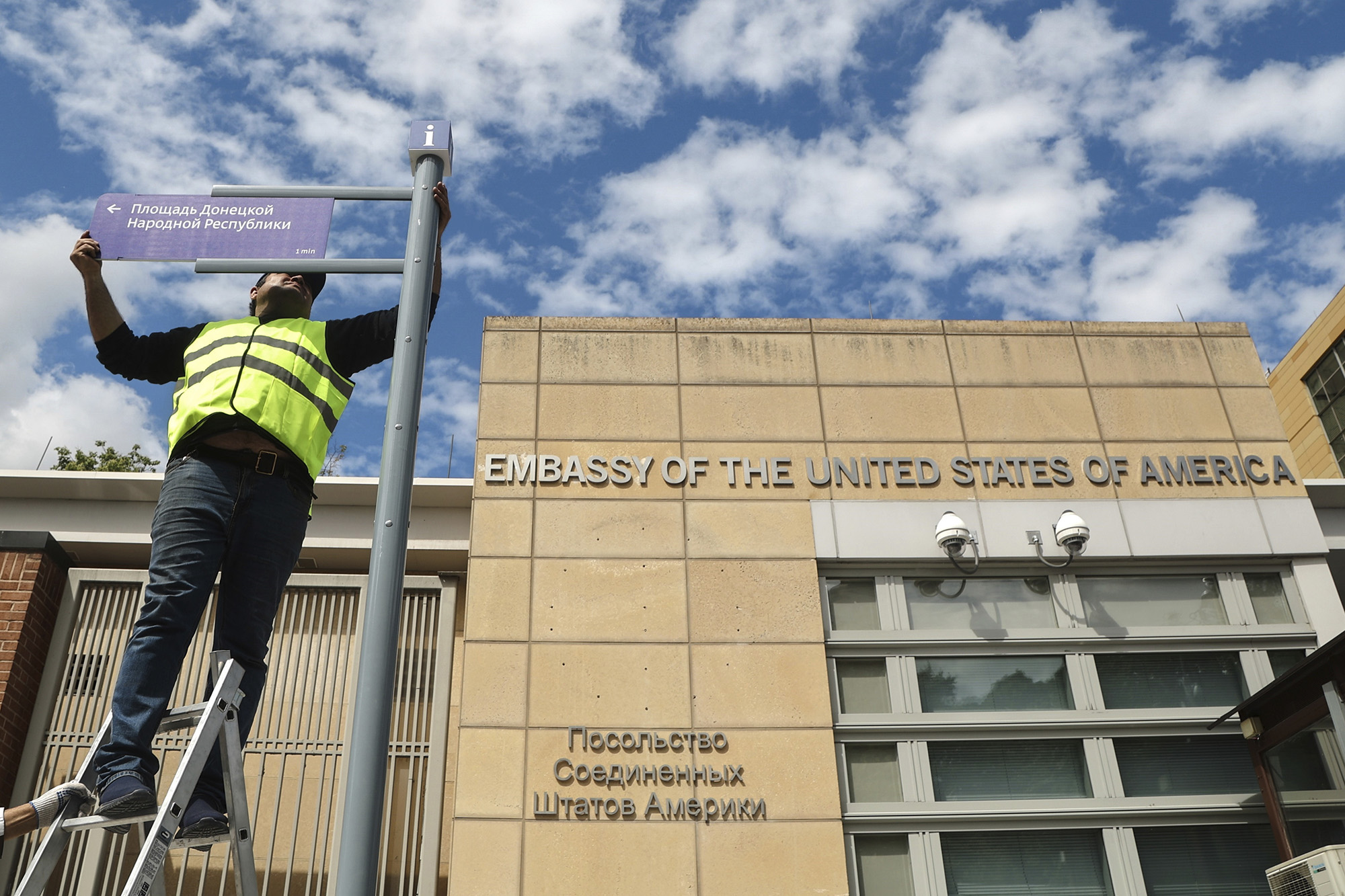 A utility worker during installation of an address sign on the Donetsk People's Republic (DPR) square near the US Embassy in Moscow, Russia, on June 22