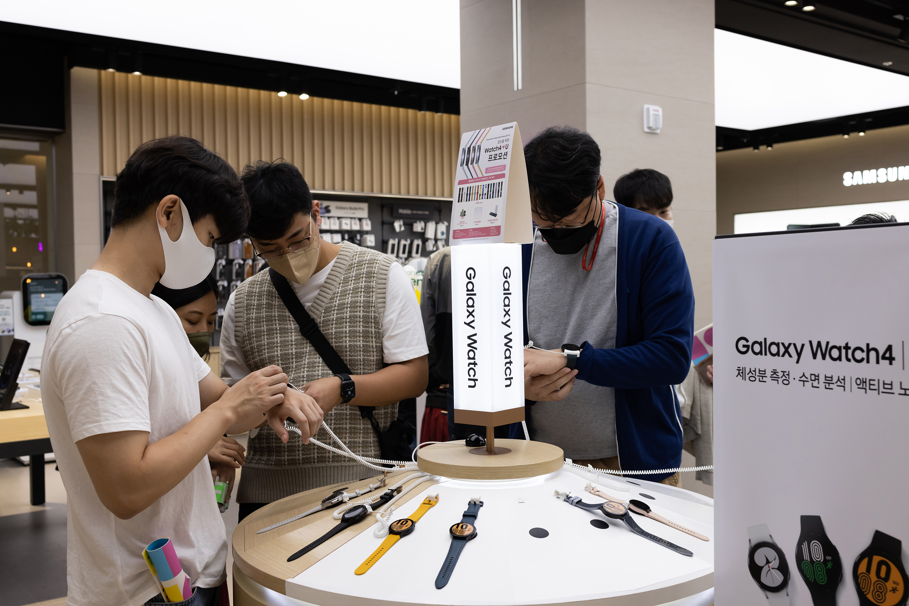 Customers try out Samsung smartwatches at the store in Seoul, South Korea, on October 3.