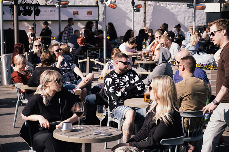 People enjoy a drink while sitting in a terrace in Helsinki on June 1, 2020.