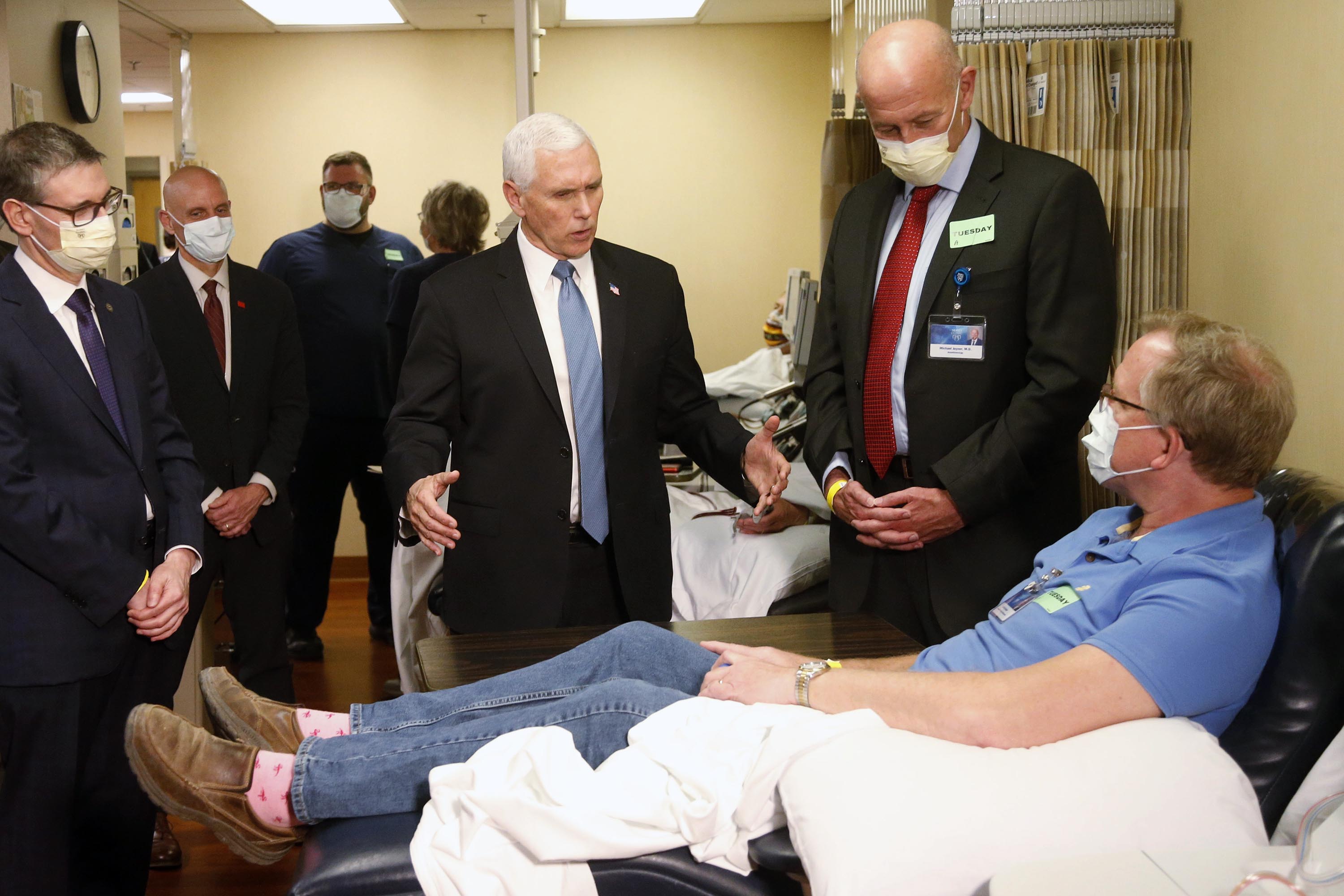 Vice President Mike Pence, center, visits Dennis Nelson, a patient who survived the coronavirus and was going to donate blood, during a tour of the Mayo Clinic in Rochester, Minnesota, on Tuesday, April 28.