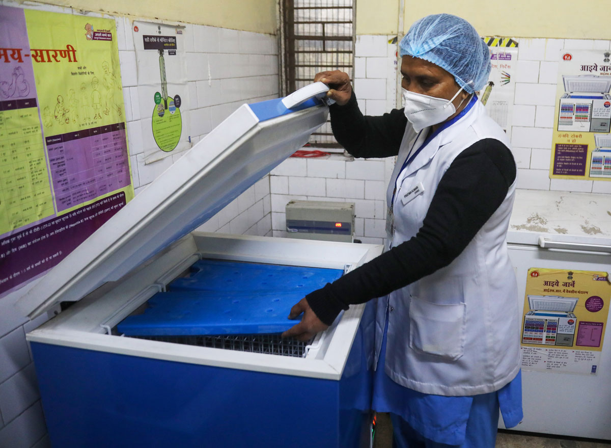 A health worker is seen opening a deep freezer during a nationwide dry run for Covid-19 vaccinations at the health care center at Darya Ganj in New Delhi, India on January 2.