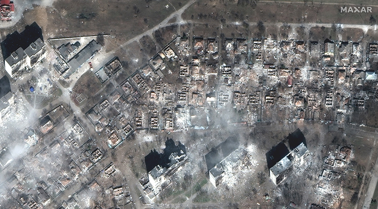 Every house surrounding two separate apartment complexes is destroyed in eastern Mariupol.