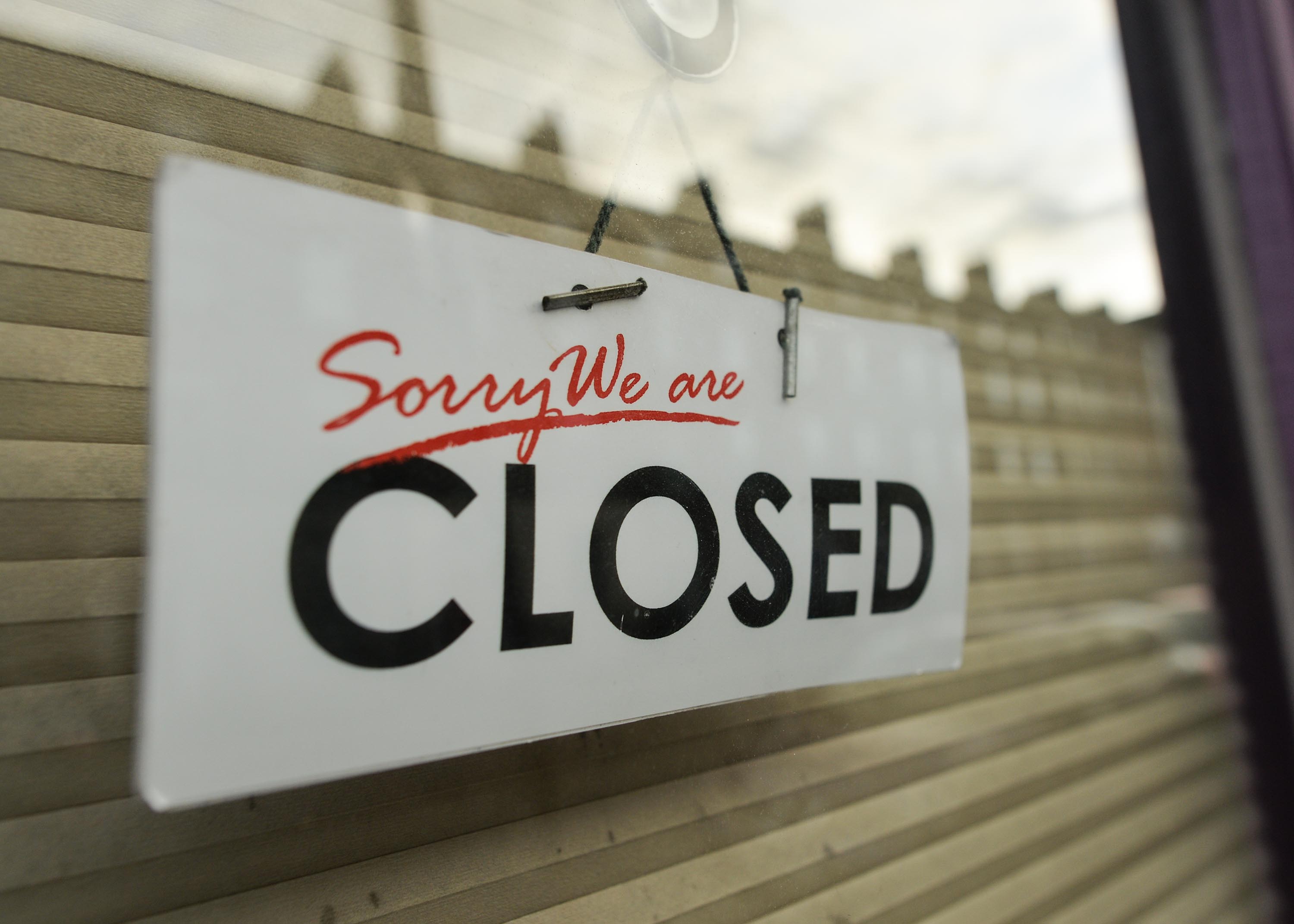 In this November 23, 2020 file photo, a closed sign is seen in a shop window in Dublin's city centre.