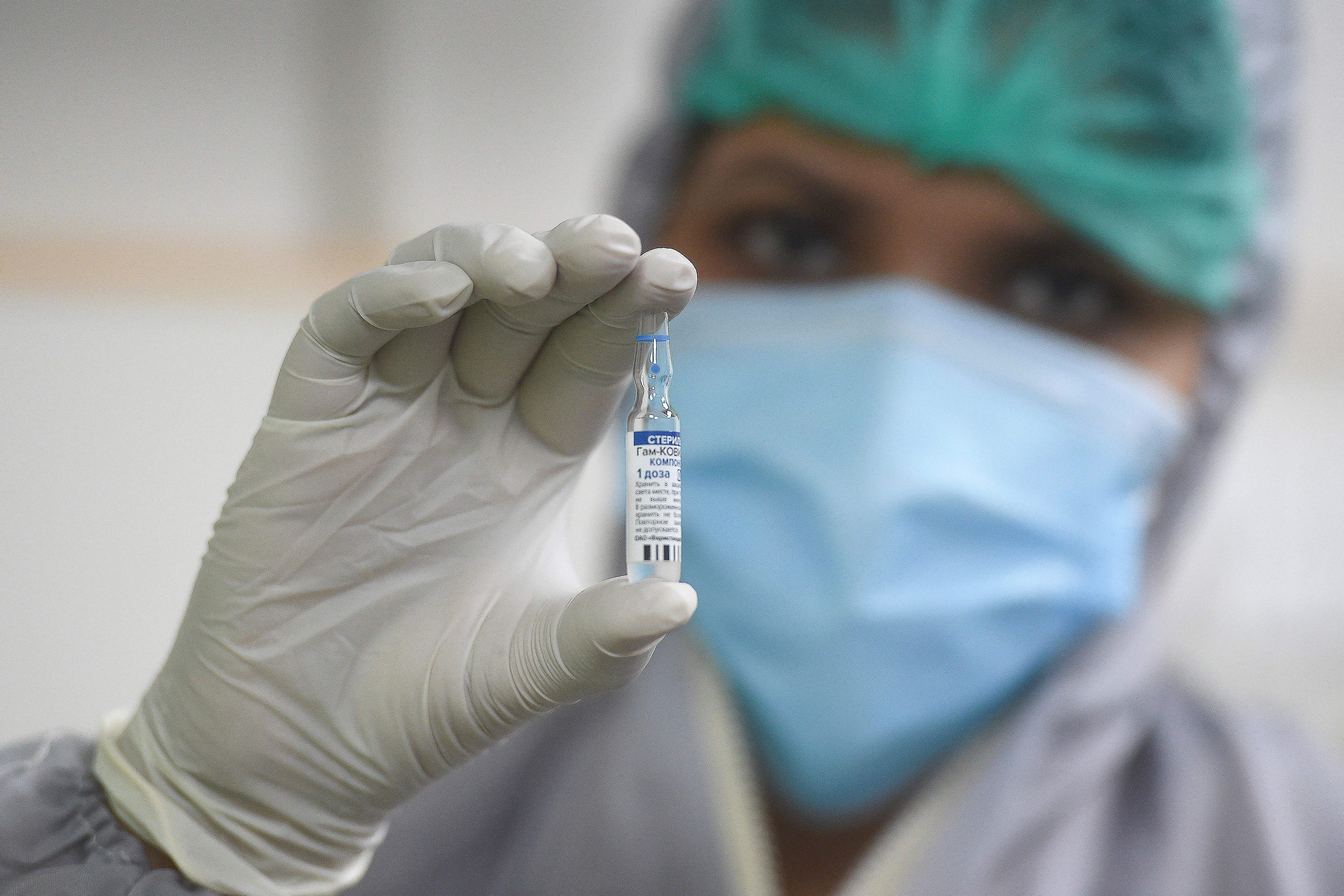 A health worker holds a dose of Russia's Sputnik V Covid-19 vaccine in Karachi, Pakistan, on April 2. 