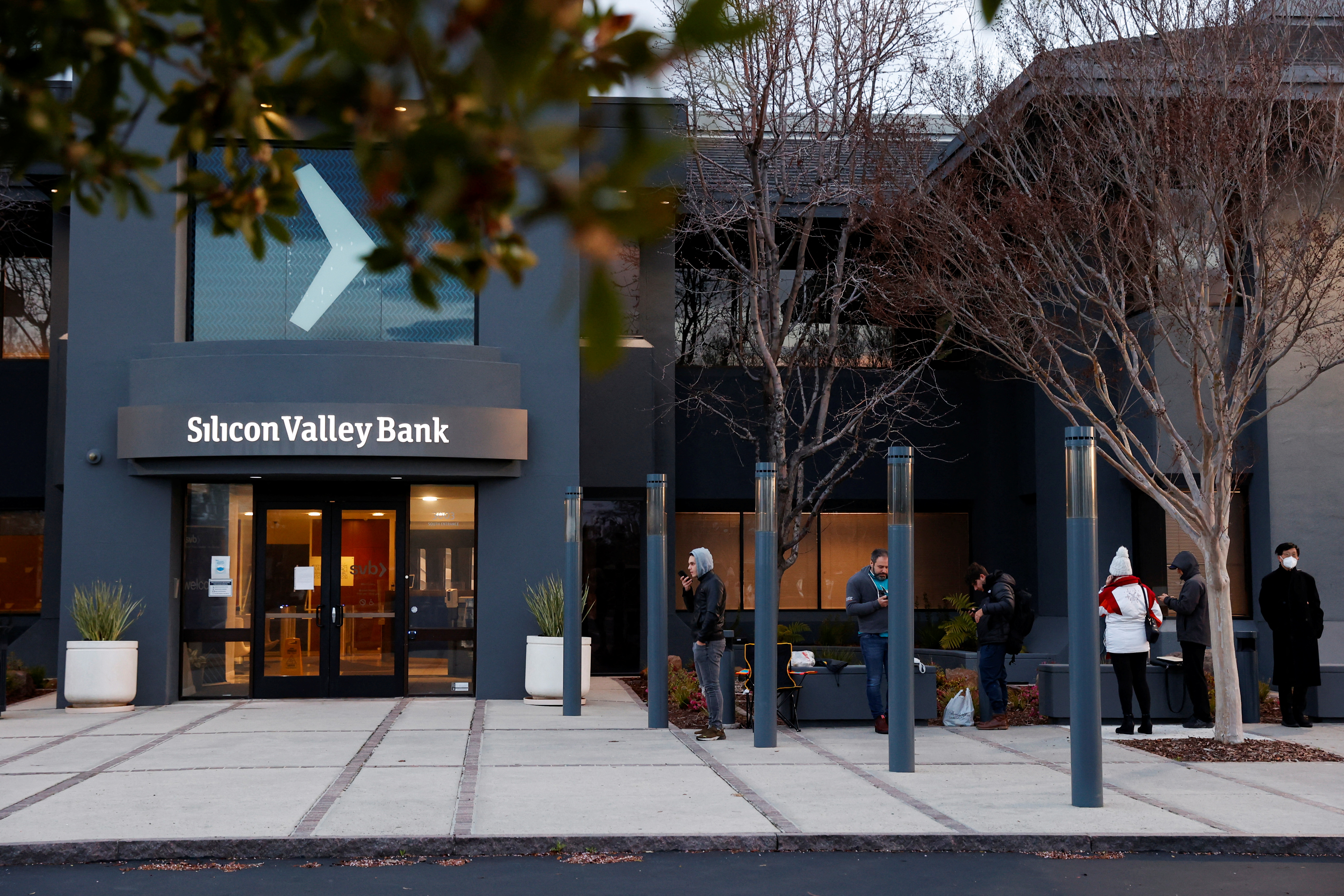 People line up outside the Silicon Valley Bank headquarters in Santa Clara, California, on March 13, 2023.