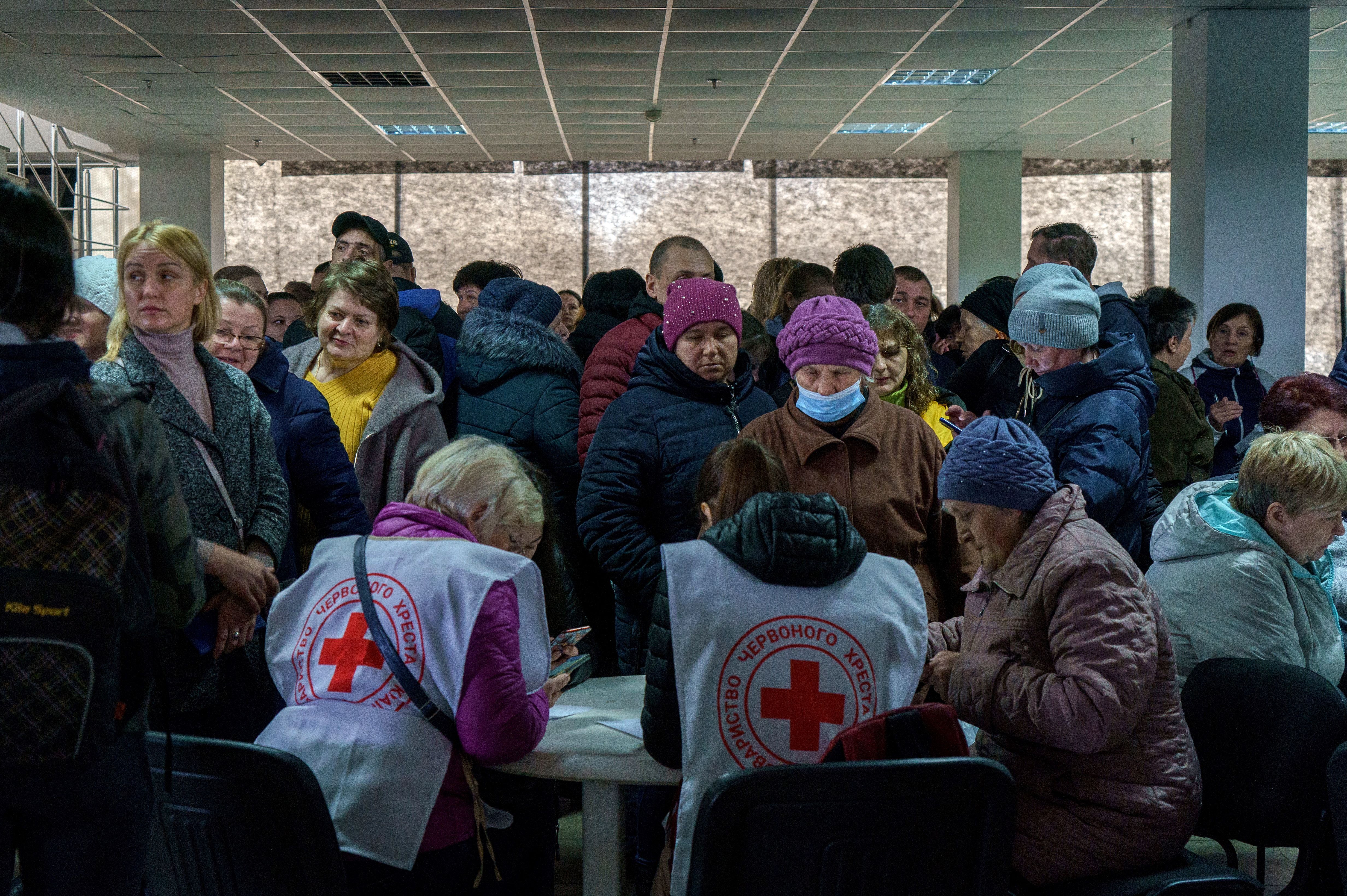 Volunteers help recipients in a Red Cross and local NGO's registration center for internally displaced people in Zaporizhzhia, Ukraine, on March 30.