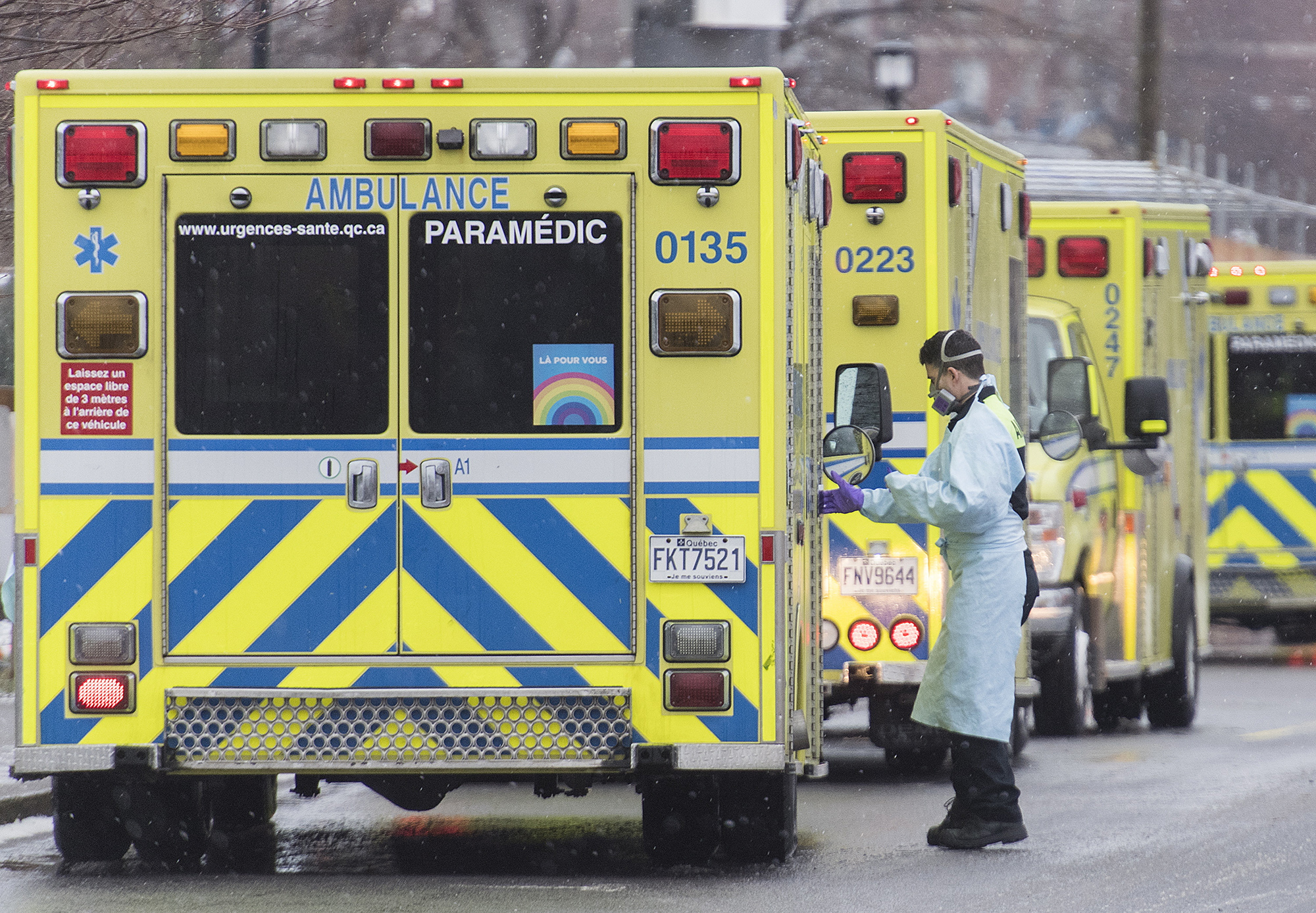 A paramedic stands next to an ambulance outside a hospital in Montreal, Canada, on Monday, December 28.