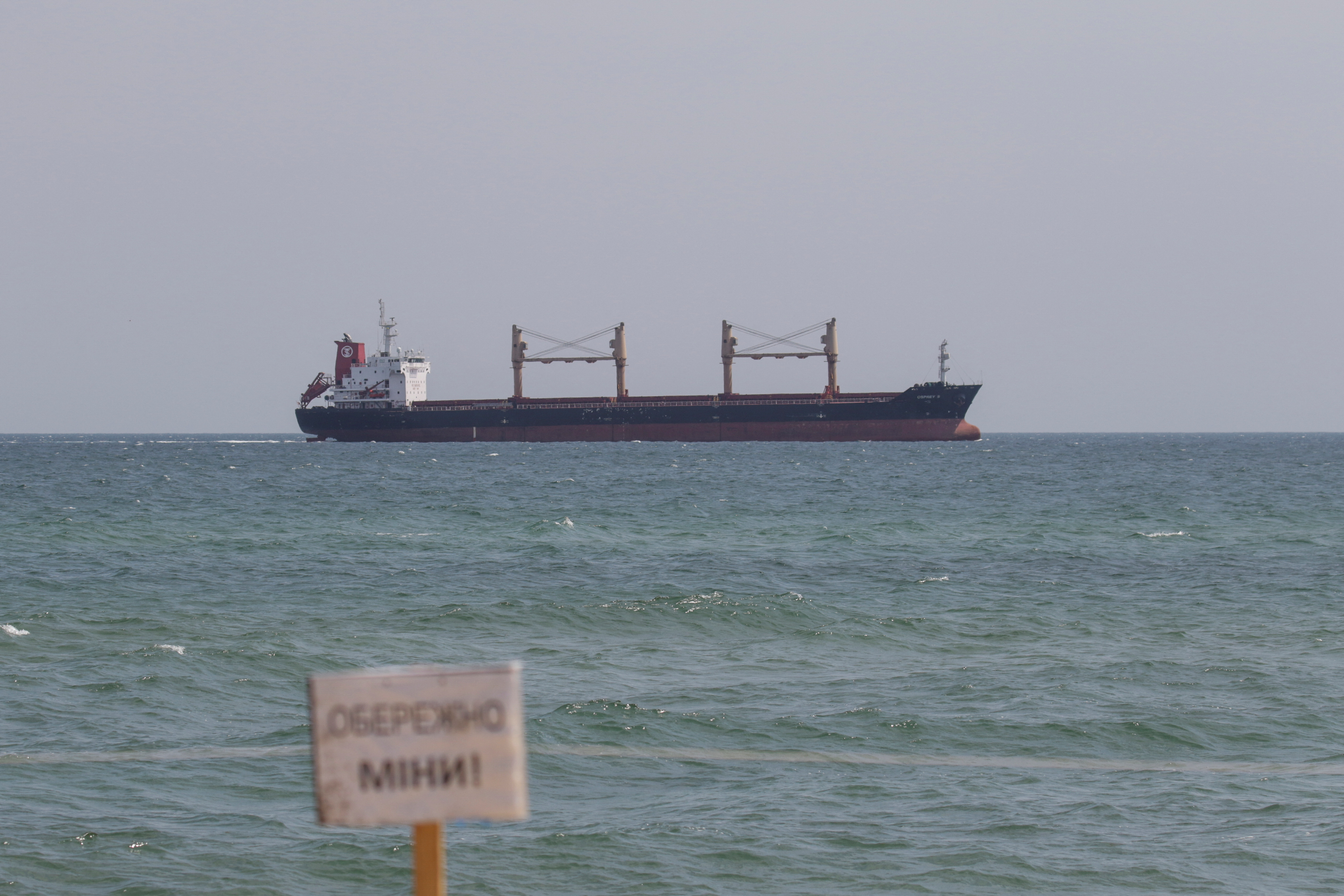 Bulk carrier Osprey S arrives to the seaport in Chornomorsk, Ukraine on Aug. 10. The sign reads: 'Caution! Mines!' 