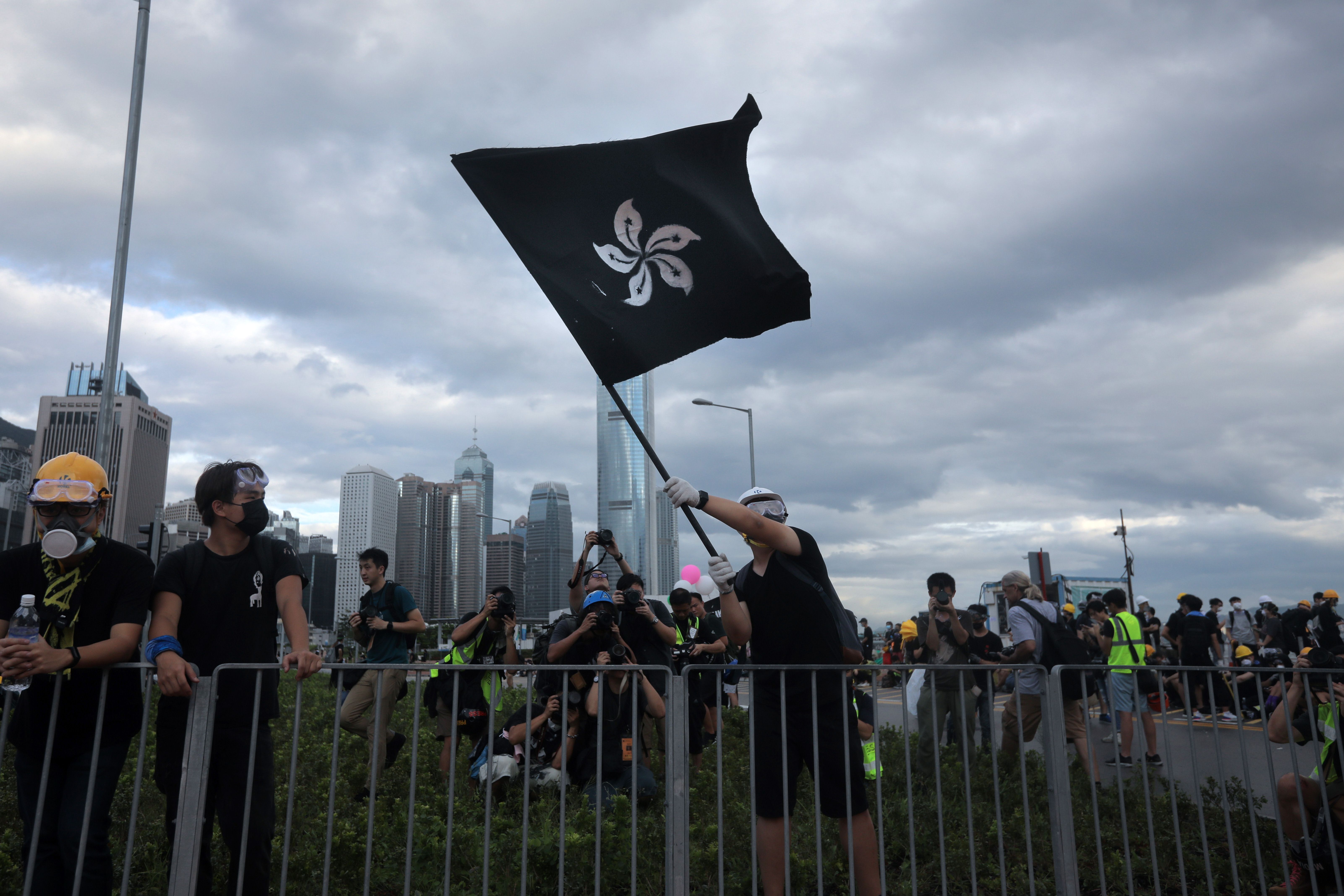 A protester waves a "black bauhinia" flag outside Hong Kong's Legislative Council.