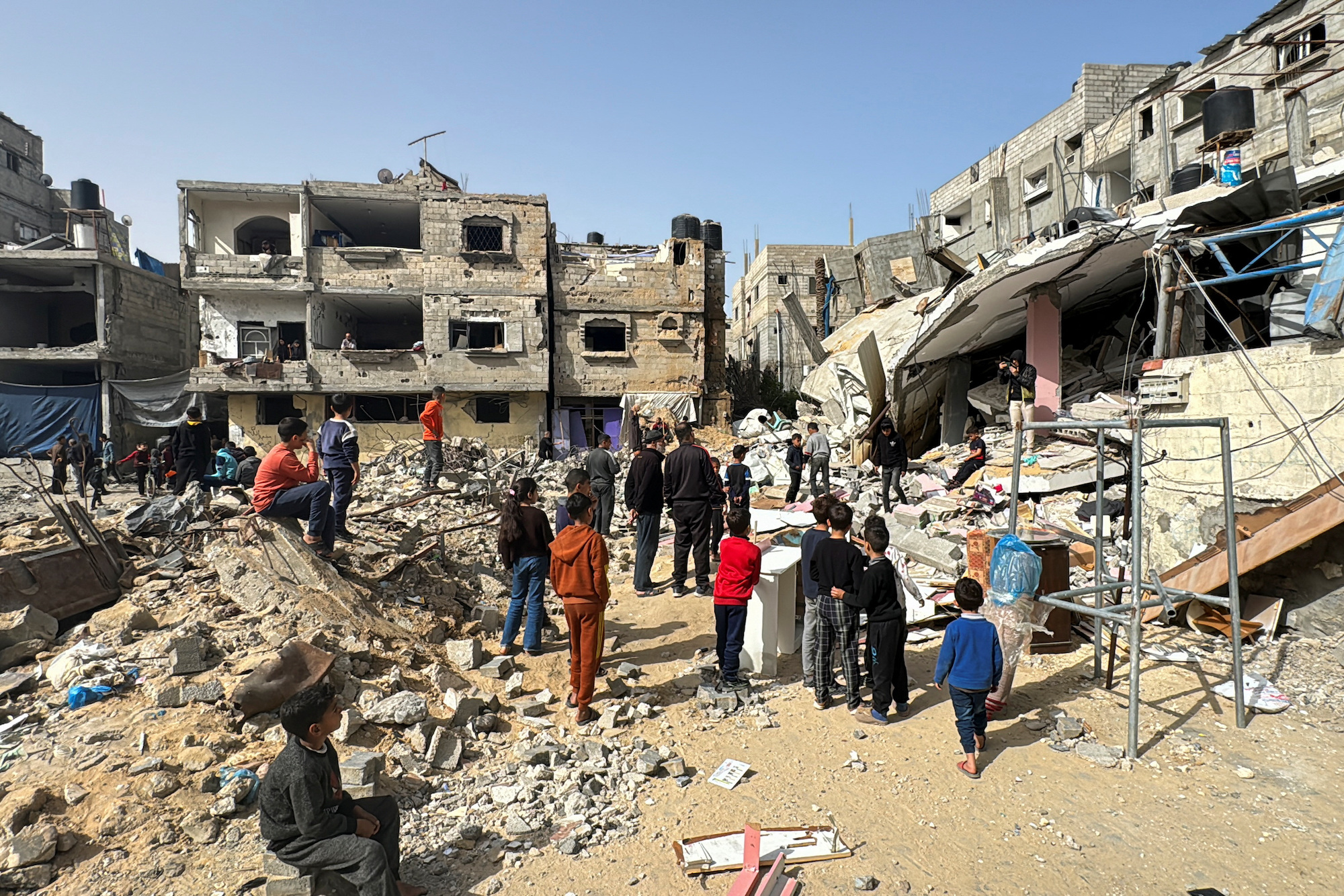 Palestinians inspect the site of an Israeli strike in Rafah, Gaza, on March 27.