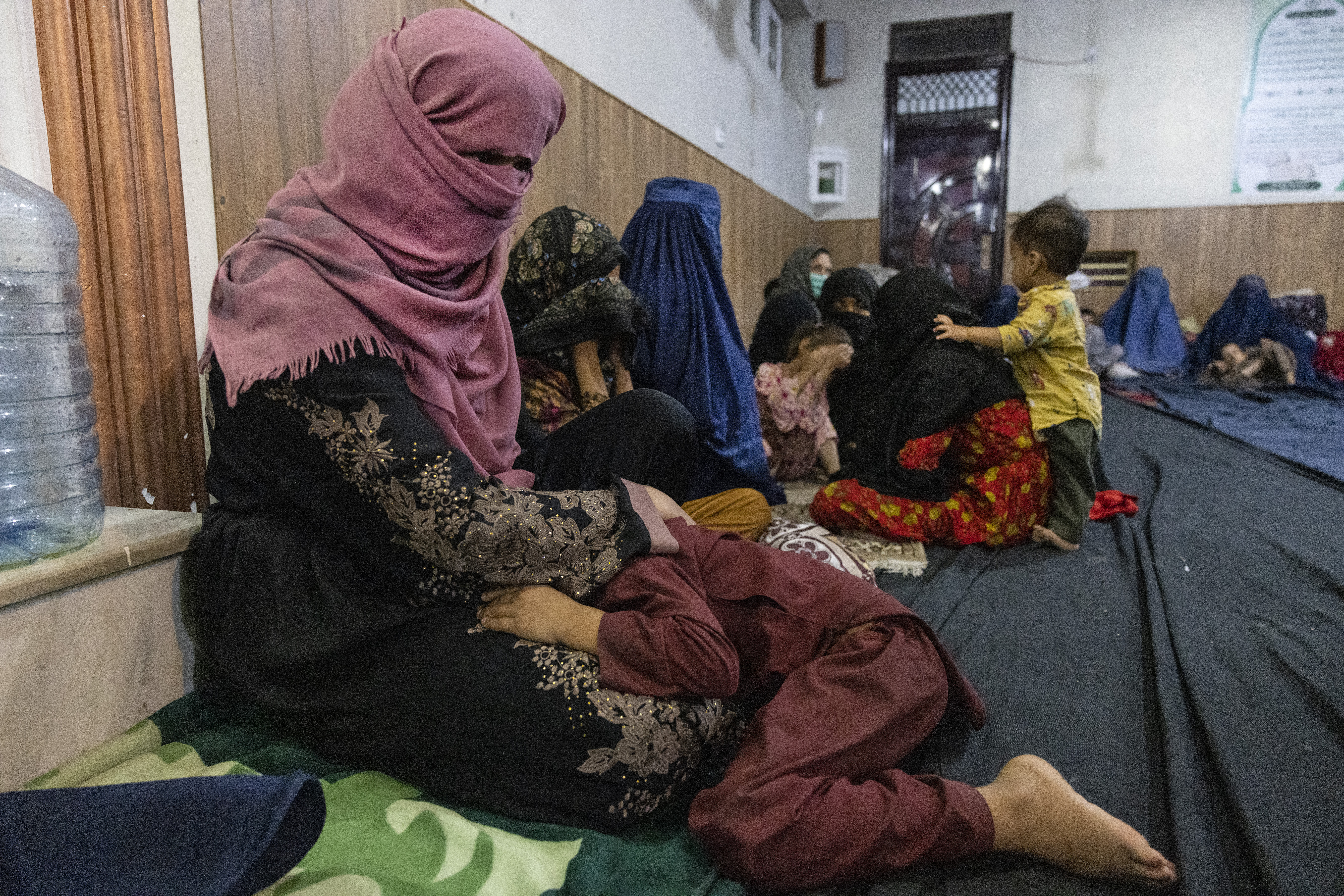 Displaced Afghan women and children from Kunduz are seen at a mosque that is sheltering them on August 13, 2021 in Kabul, Afghanistan.