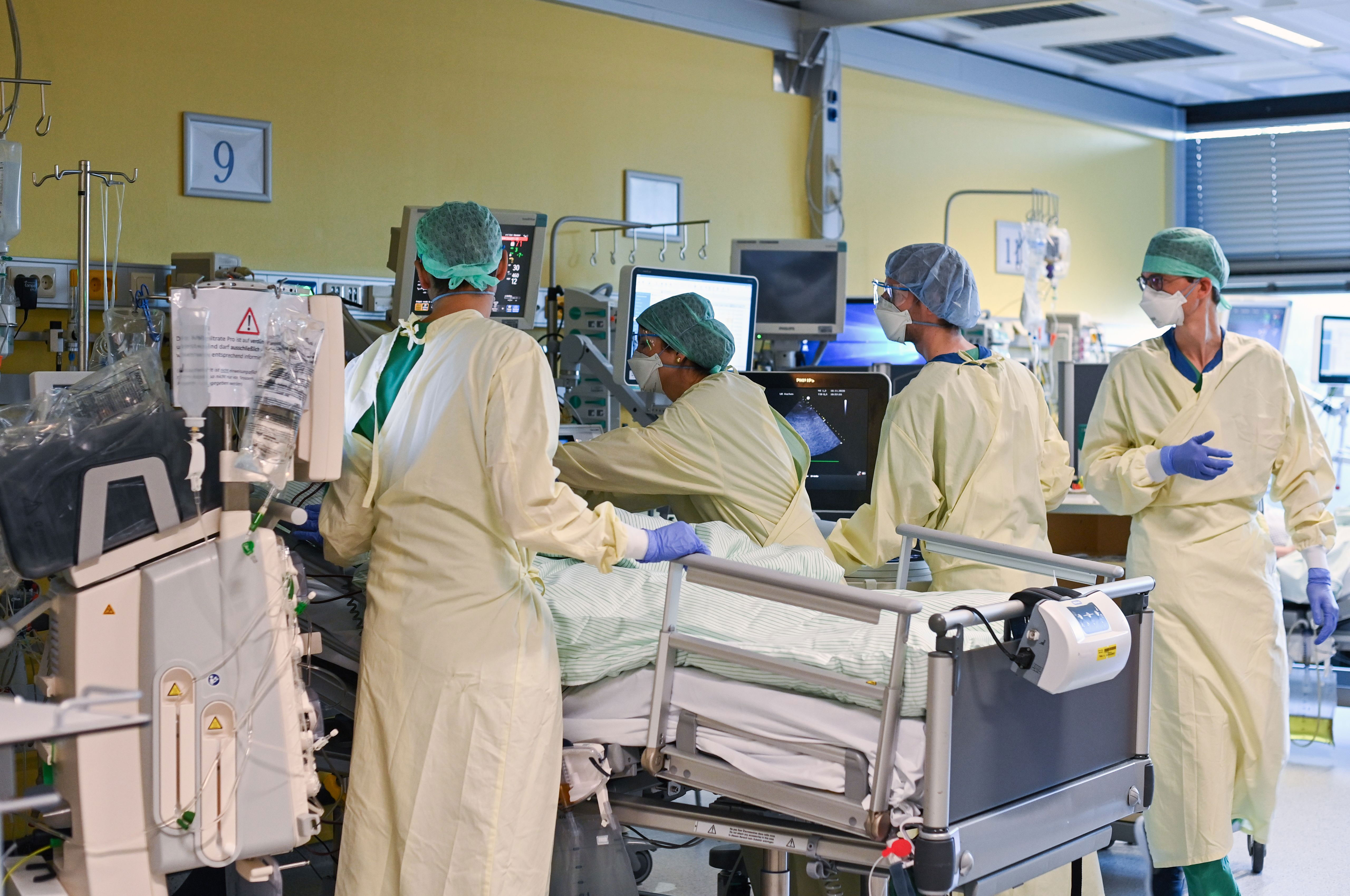 Medical personnel at a hospital in Aachen, Germany, examine a Covid-19 patient in the intensive care unit on November 10.