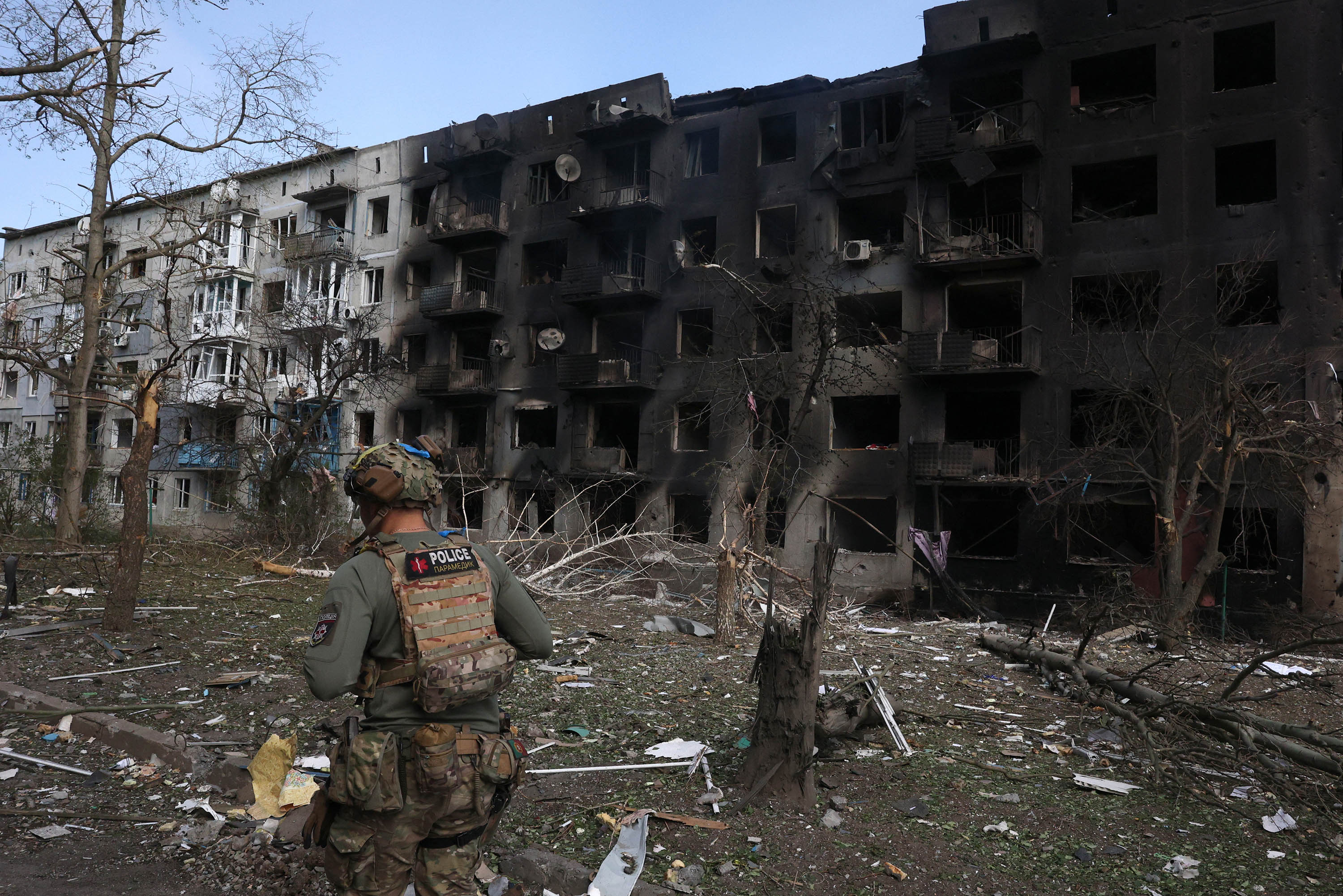A Ukrainian police officer walks past a destroyed residential building, following artillery and air raids in the village of Ocheretyne, in Ukraine's Donetsk region on April 15. 