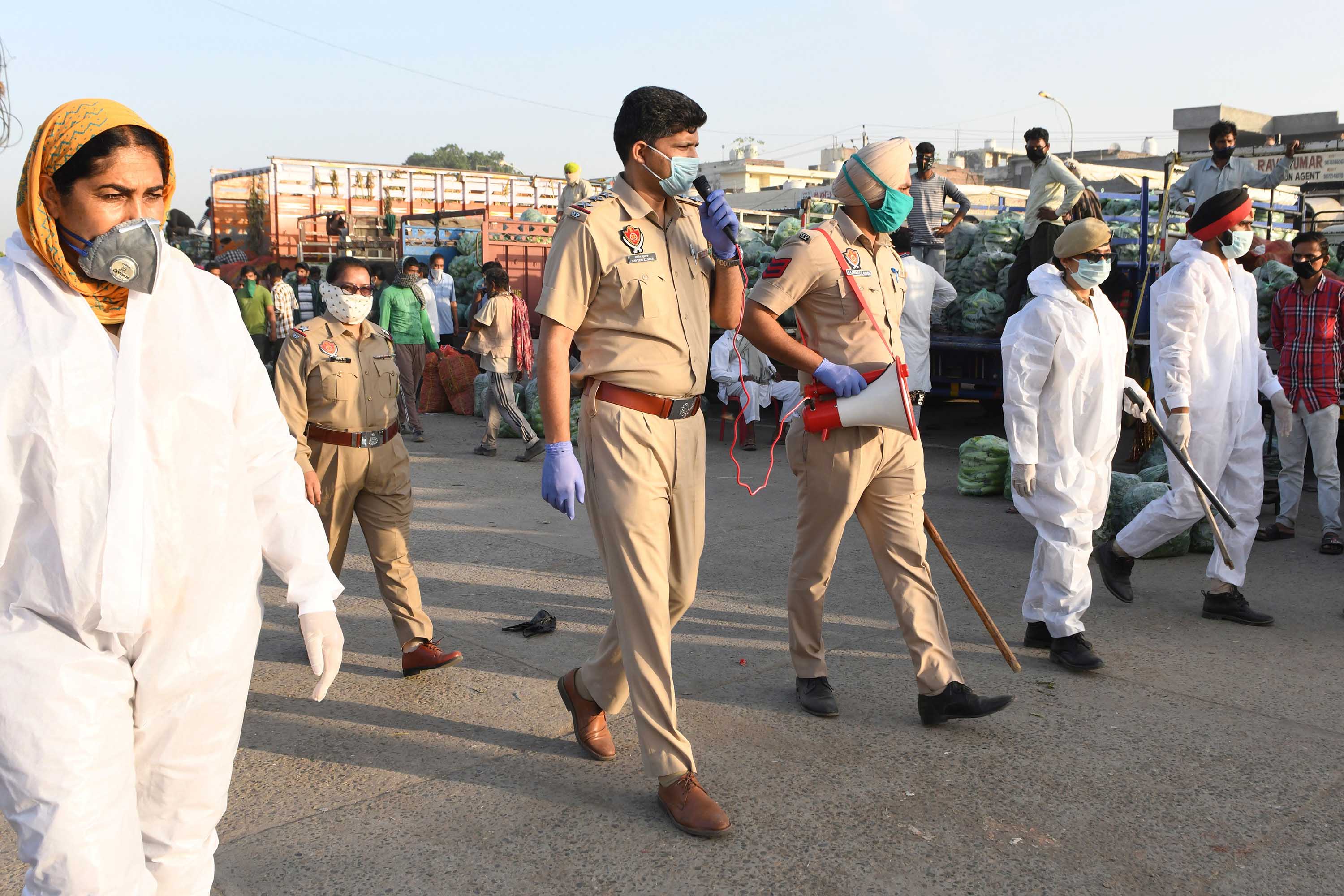 Punjab police personnel patrol a vegetable market during a government-imposed nationwide lockdown on the outskirts of Amritsar, India, on May 1.