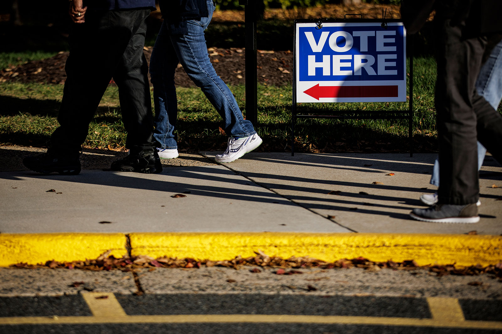 People walk towards an early voting location in Stafford, Virginia, on November 3.