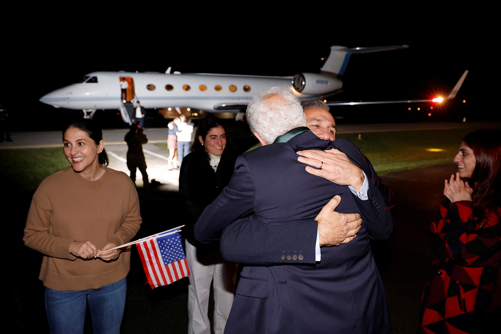 Family members embrace freed Americans Siamak Namazi, Morad Tahbaz and Emad Shargi — as well as two returnees whose names have not yet been released by the U.S. government — as they arrive at Davison Army Airfield at Fort Belvoir, Virginia, U.S., on September 19.