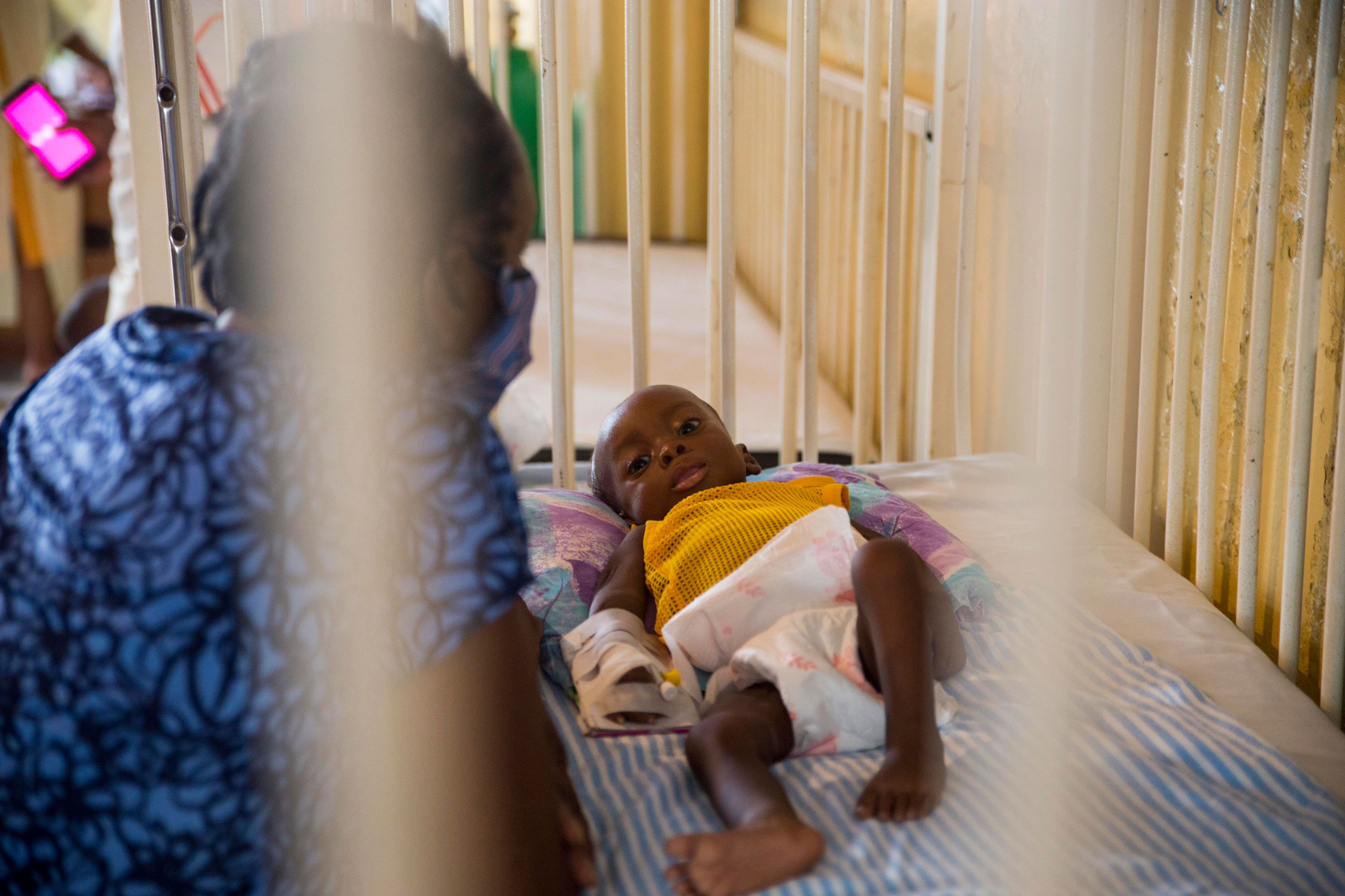 Marie Rose Emile watches over her 6-month-old grandson Jonise as he is treated for malnutrition at the Hospital of Immaculate Conception, in Les Cayes, Haiti, on Wednesday, May 26. 