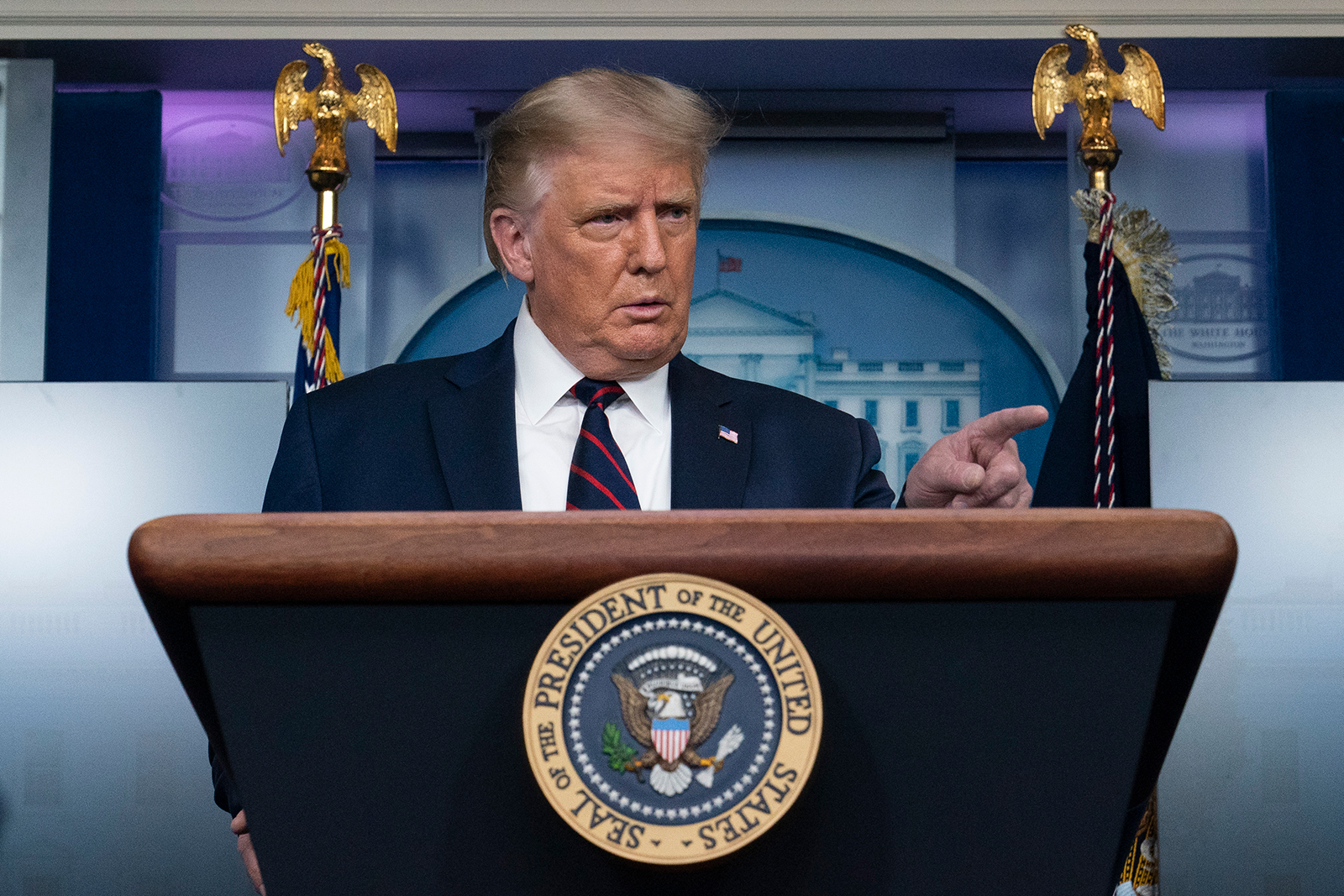 President Donald Trump points to reporter to ask a question during a briefing at the White House on Sunday, August 23.