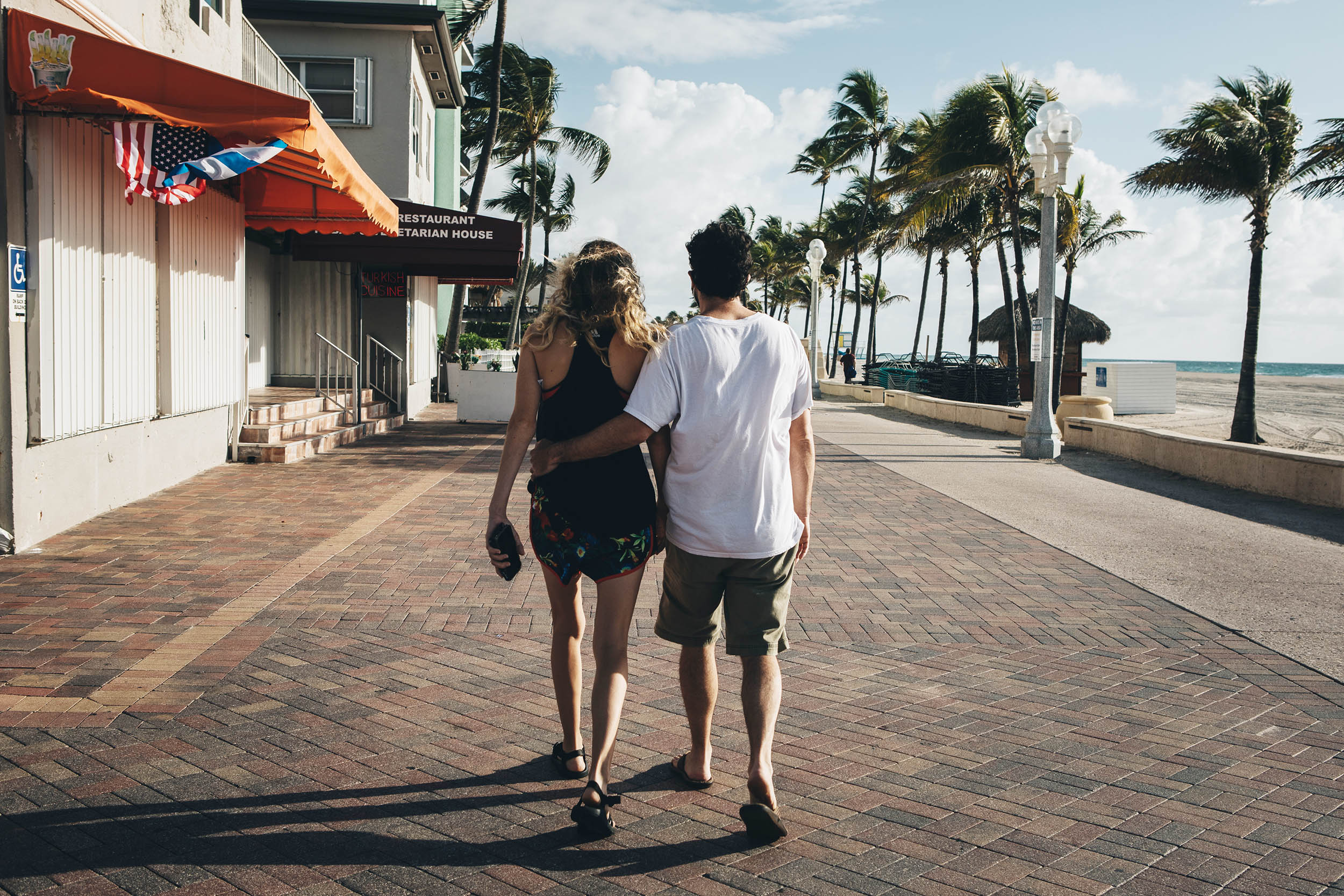 A couple walks along the Hollywood Boardwalk in Hollywood, Florida, on Saturday, May 23. 