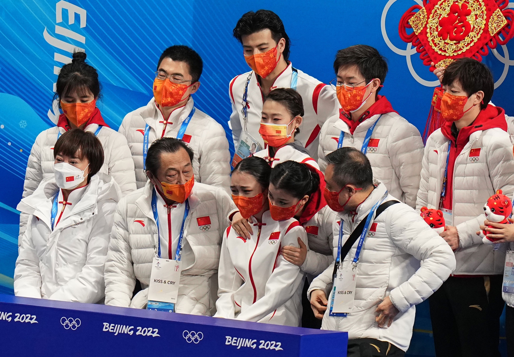 Zhu Yi's teammates console her after her performance at the women single free skating team event on Monday.