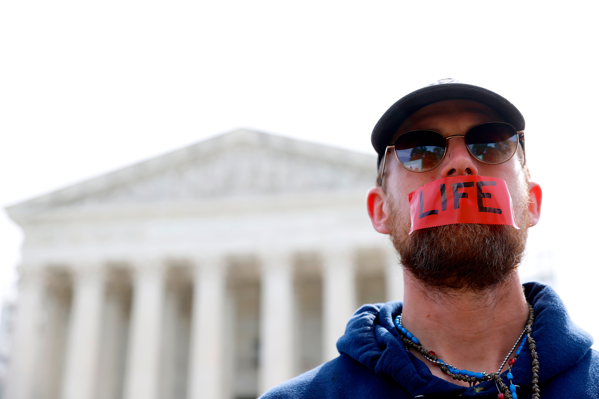 A demonstrator with the word "LIFE" written on tape covering his mouth stands outside the US Supreme Court on Wednesday.