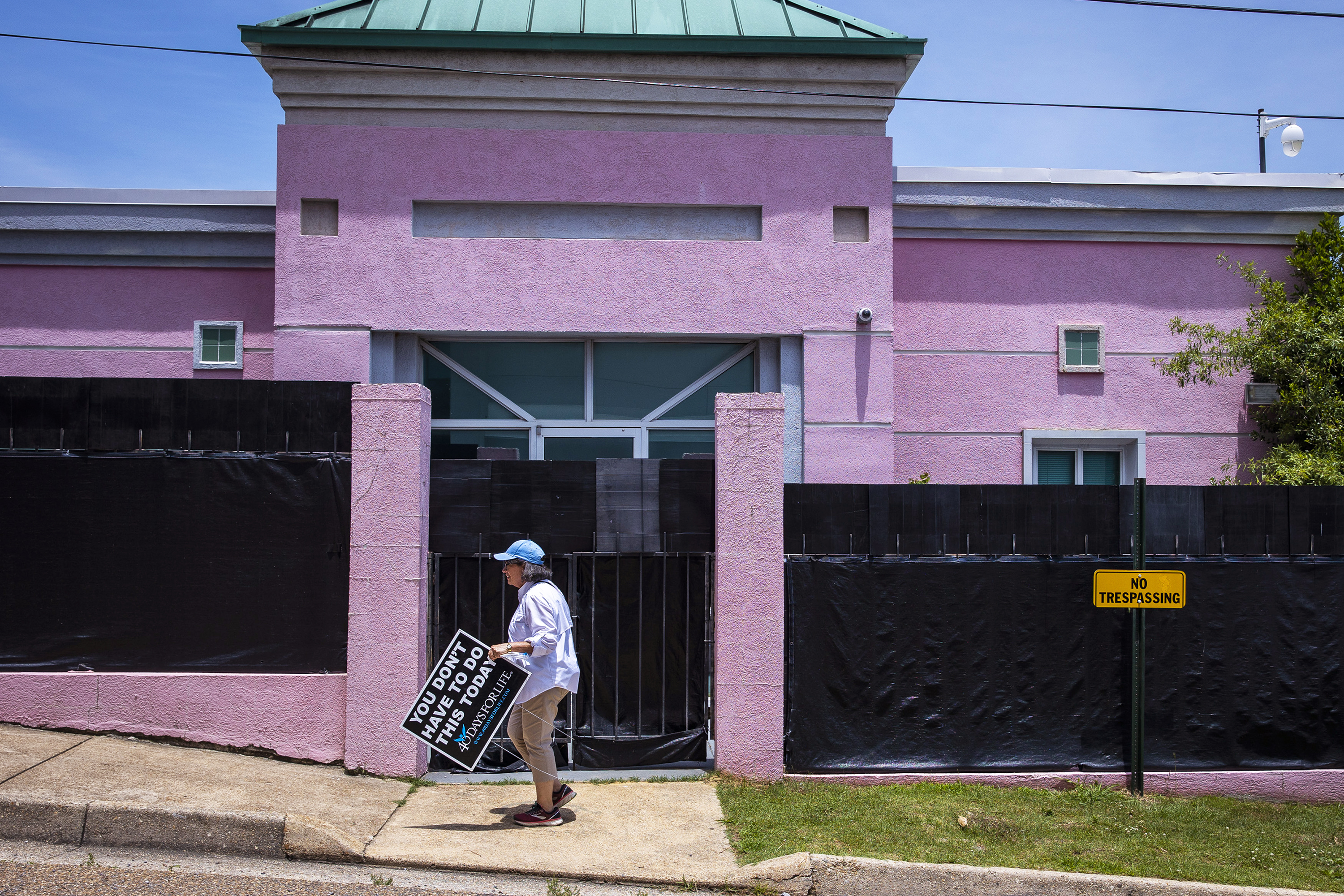 An anti-abortion protester holds a sign from outside at the Jackson Women’s Health Organization also known as the The Pink House in Jackson, Mississippi on June 7, 2022.