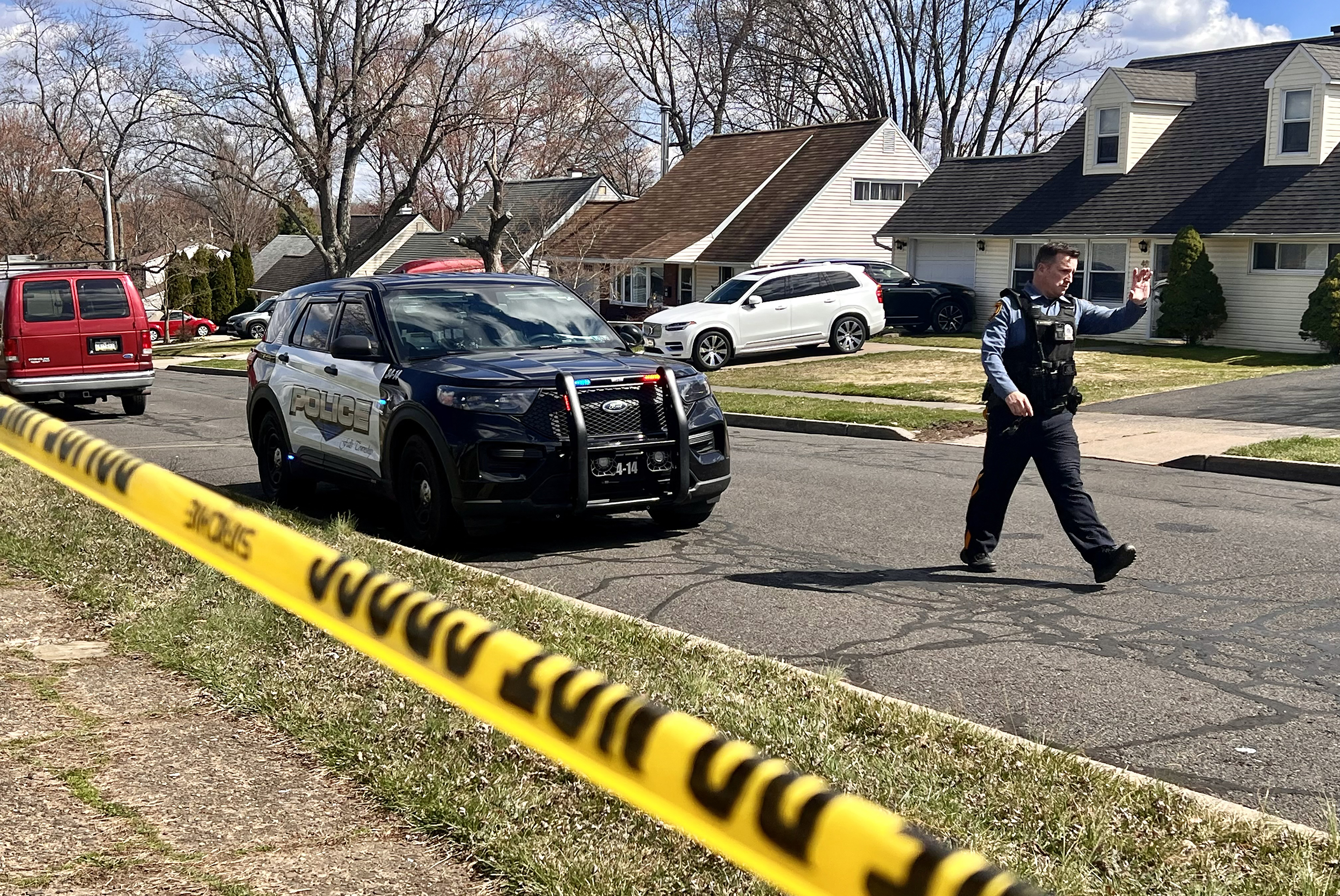 A police officer patrols a neighborhood during an active shooter situation in Levittown, a community within Falls Township, Pennsylvania, where a a shelter-in-place order was issued on March 16.