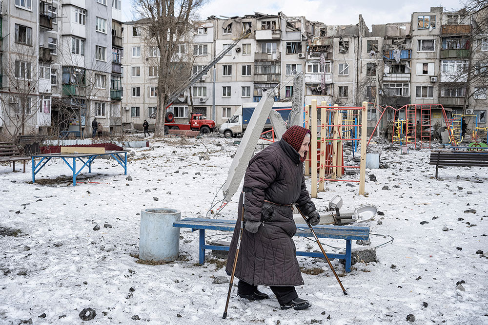 A woman walks on a playground after an apartment block was heavily damaged by a missile strike in Pokrovsk, Ukraine, on Wednesday, February 15.