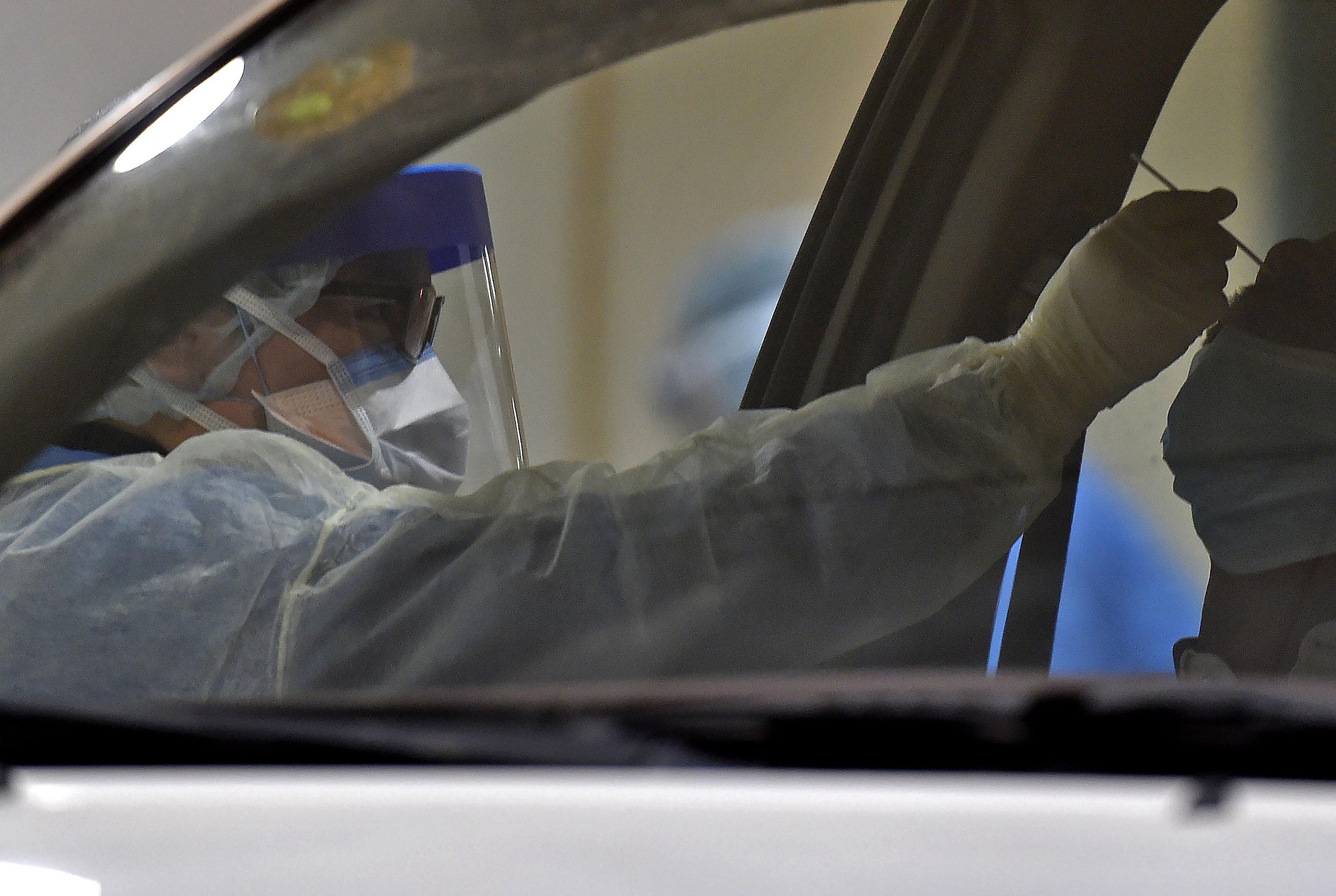 Health workers perform a nose swab during a drive-through coronavirus testing site at Diriyah hospital in the Saudi capital Riyadh on May 7.