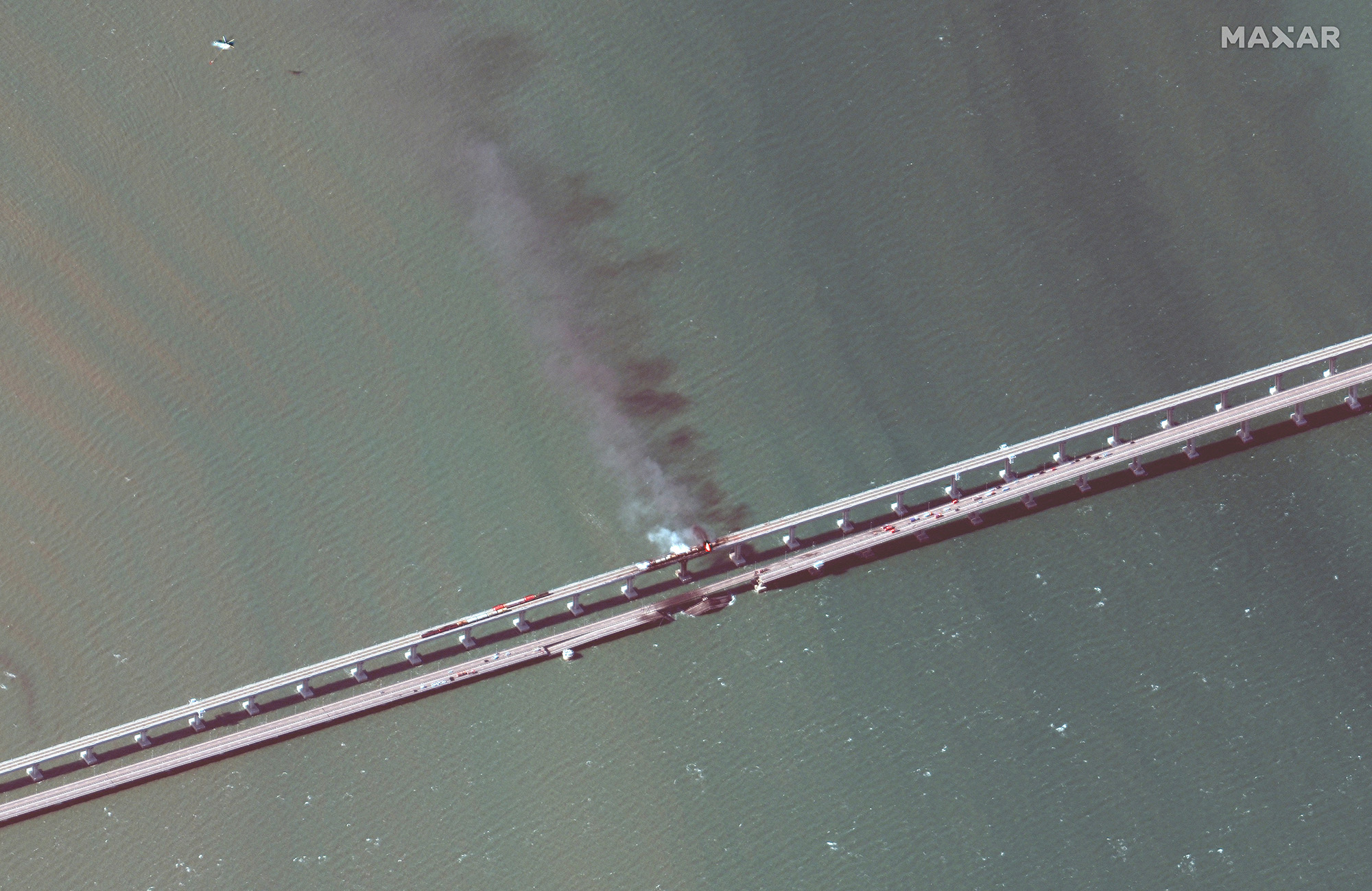 A satellite image shows smoke rising from a fire on the Kerch bridge in the Kerch Strait, Crimea, on October 8.