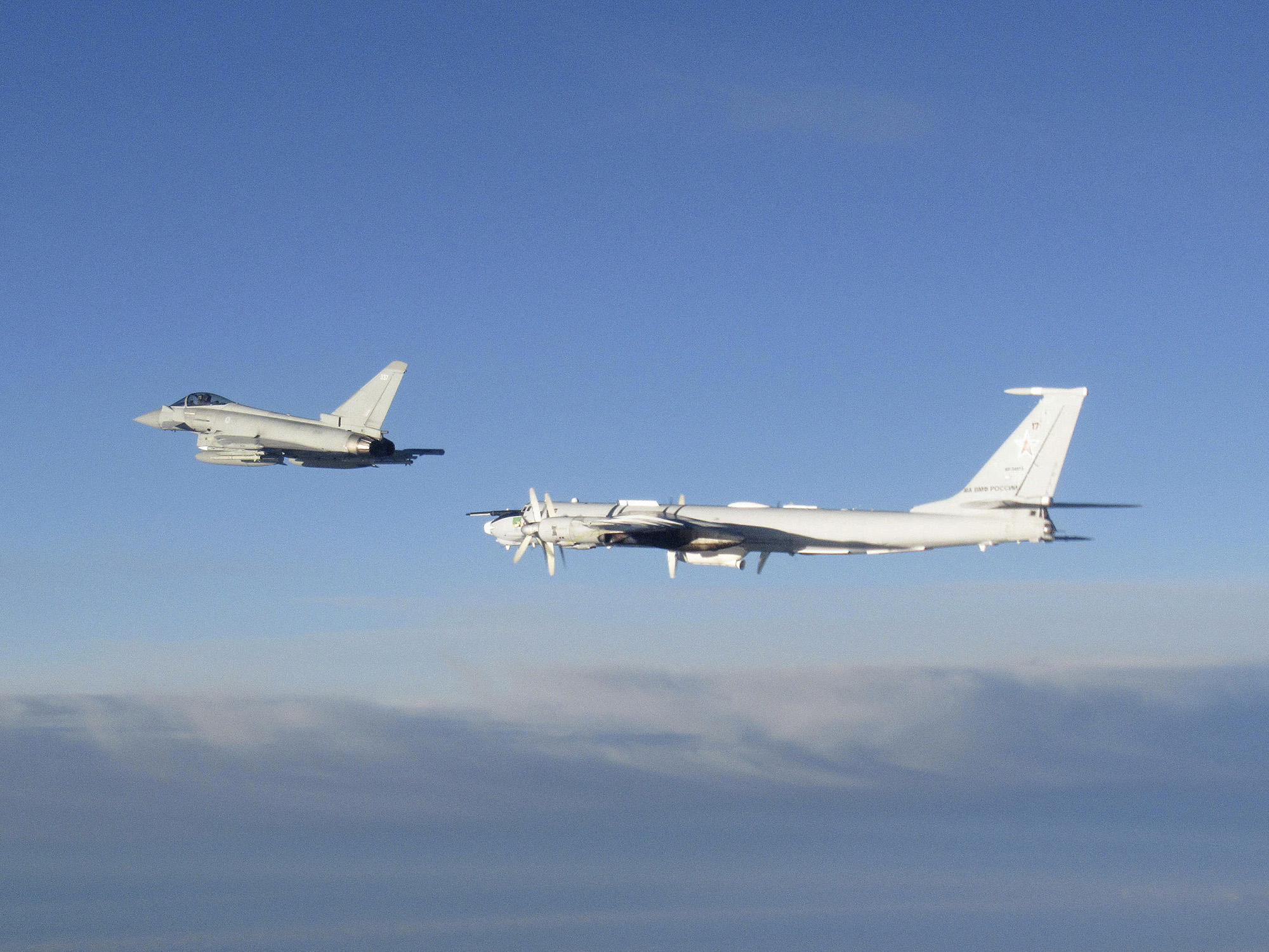 An RAF Typhoon, left, monitors a Russian Tupolev Tu-142 maritime reconnaissance and anti-submarine warfare (ASW) aircraft on August 14.