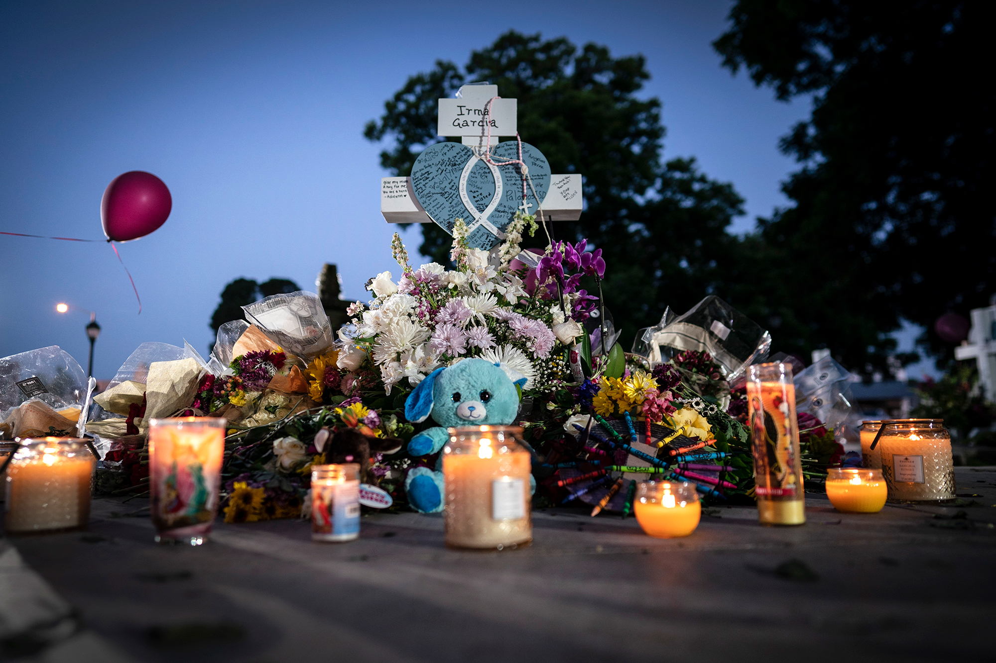 Flowers and candles adorn a memorial site for the victims of the Robb Elementary shooting, on Friday, May 27, in Uvalde, Texas. 