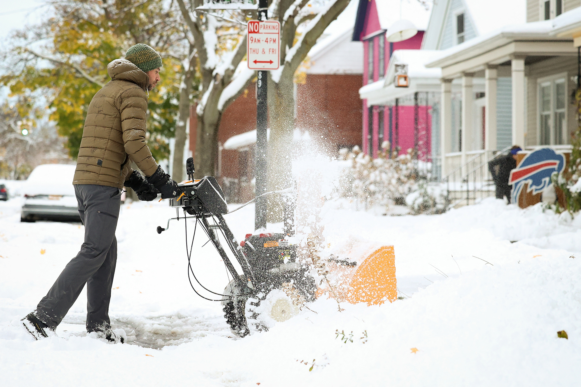 A resident plows his driveway during a snowstorm as extreme winter weather hits Buffalo, New York, Friday.