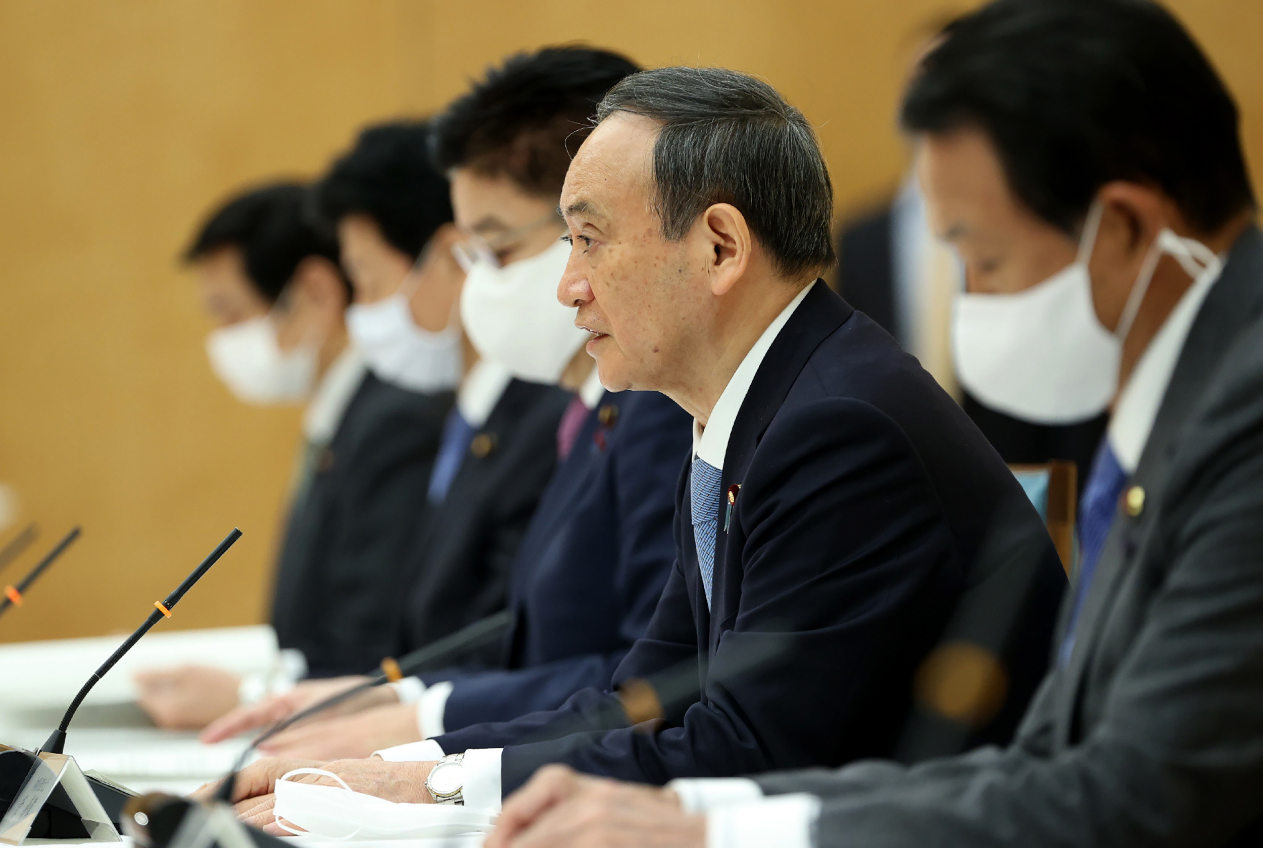 Japanese Prime Minister Yoshihide Suga, second from right, speaks at a meeting of the government and ruling parties policy at the prime minister's office in Tokyo on December 8.