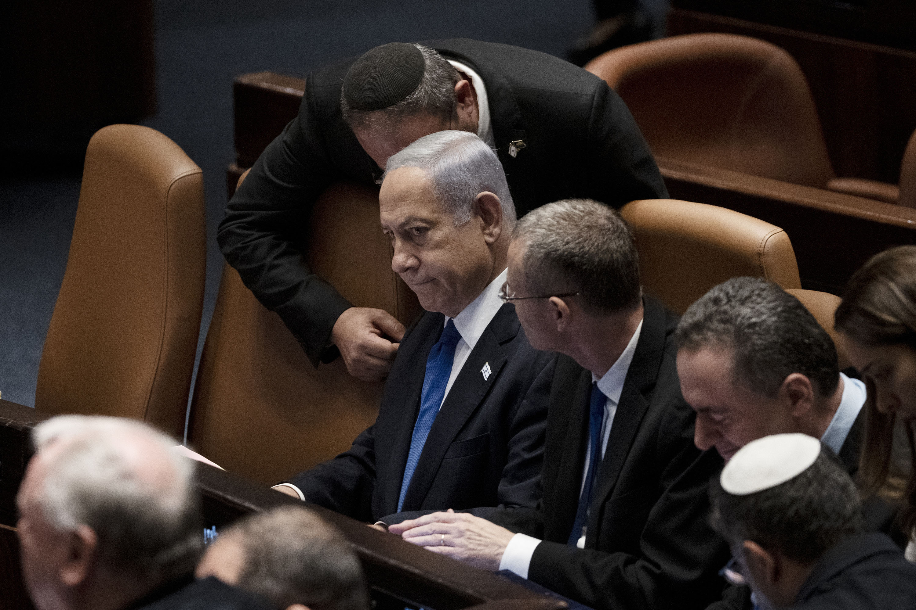 Israel's Prime Minister Benjamin Netanyahu, center, is surrounded by lawmakers at a session of the Knesset, Israel's parliament, in Jerusalem, Israel, Monday, July 24.