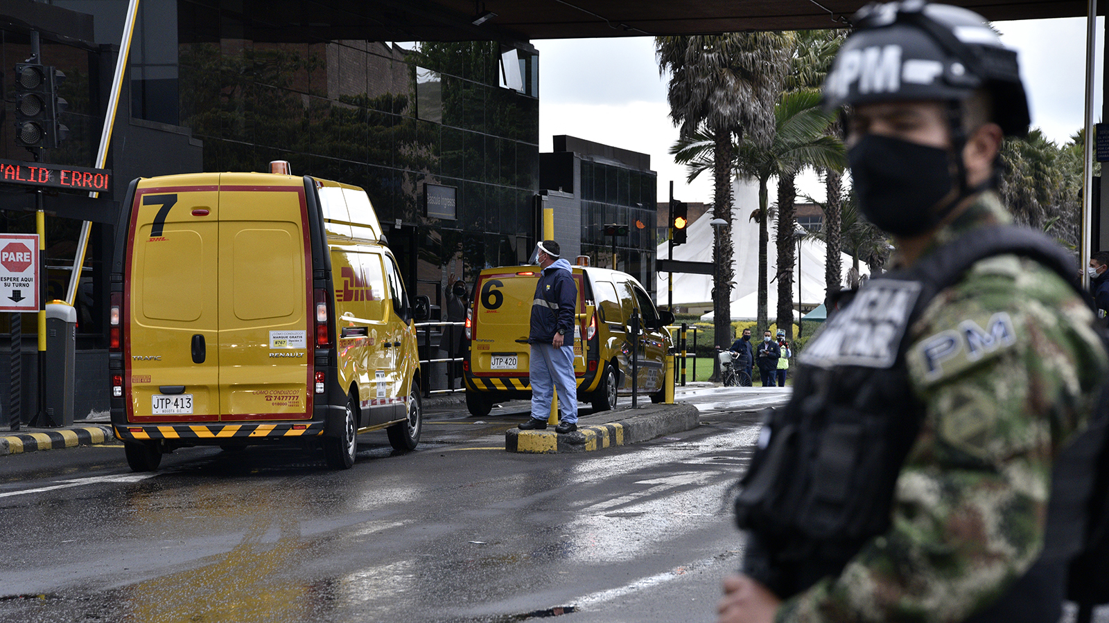 A soldier stands guard as DHL company vans transport a batch of doses of the Pfizer-BioNTech Covid-19 vaccine to the Free Trade Zone to be stored in freezers on February 15, in Bogota, Colombia.