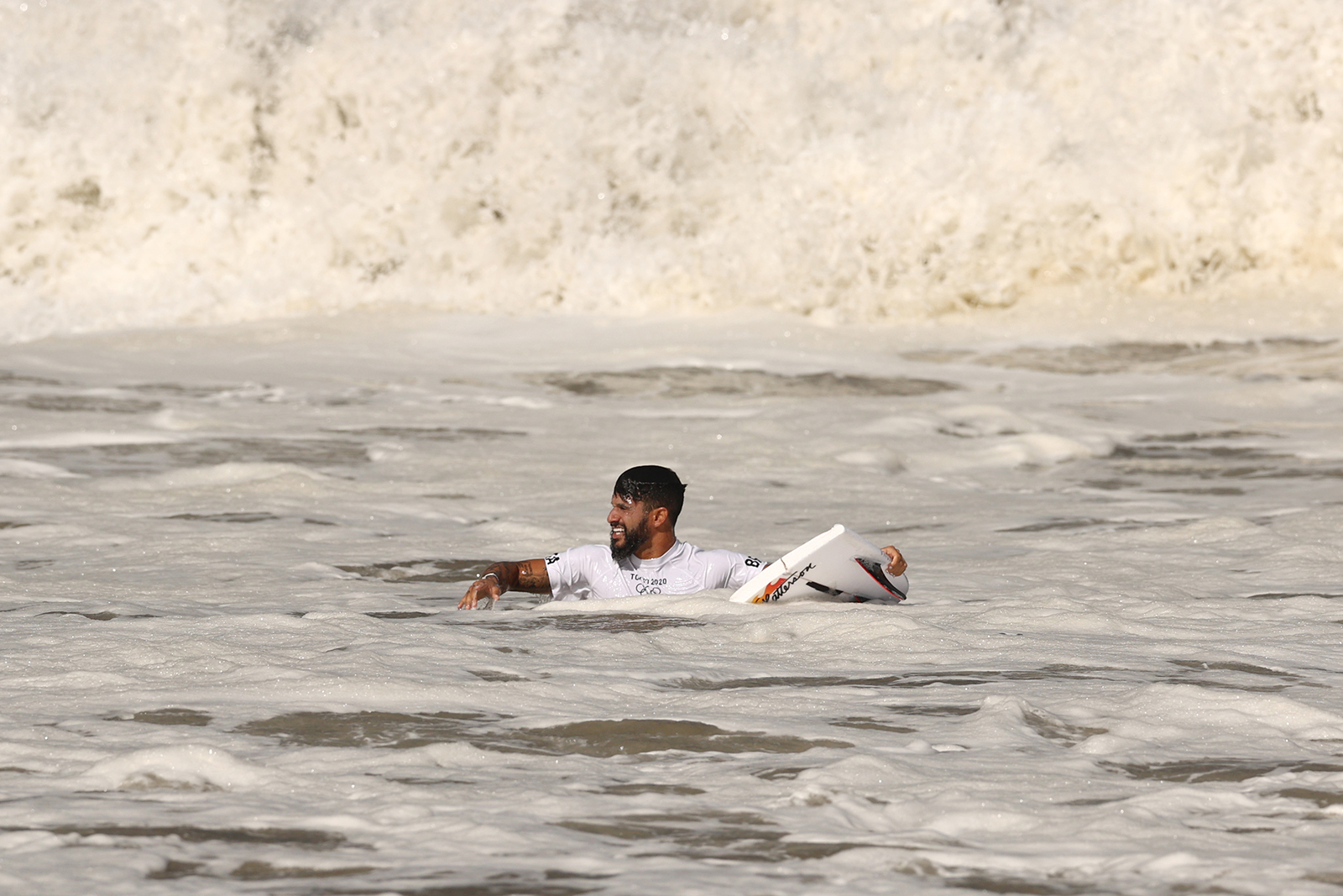 Italo Ferreira holds a broken board on his opening wave of the men's Gold Medal match at Tsurigasaki Surfing Beach on July 27. 