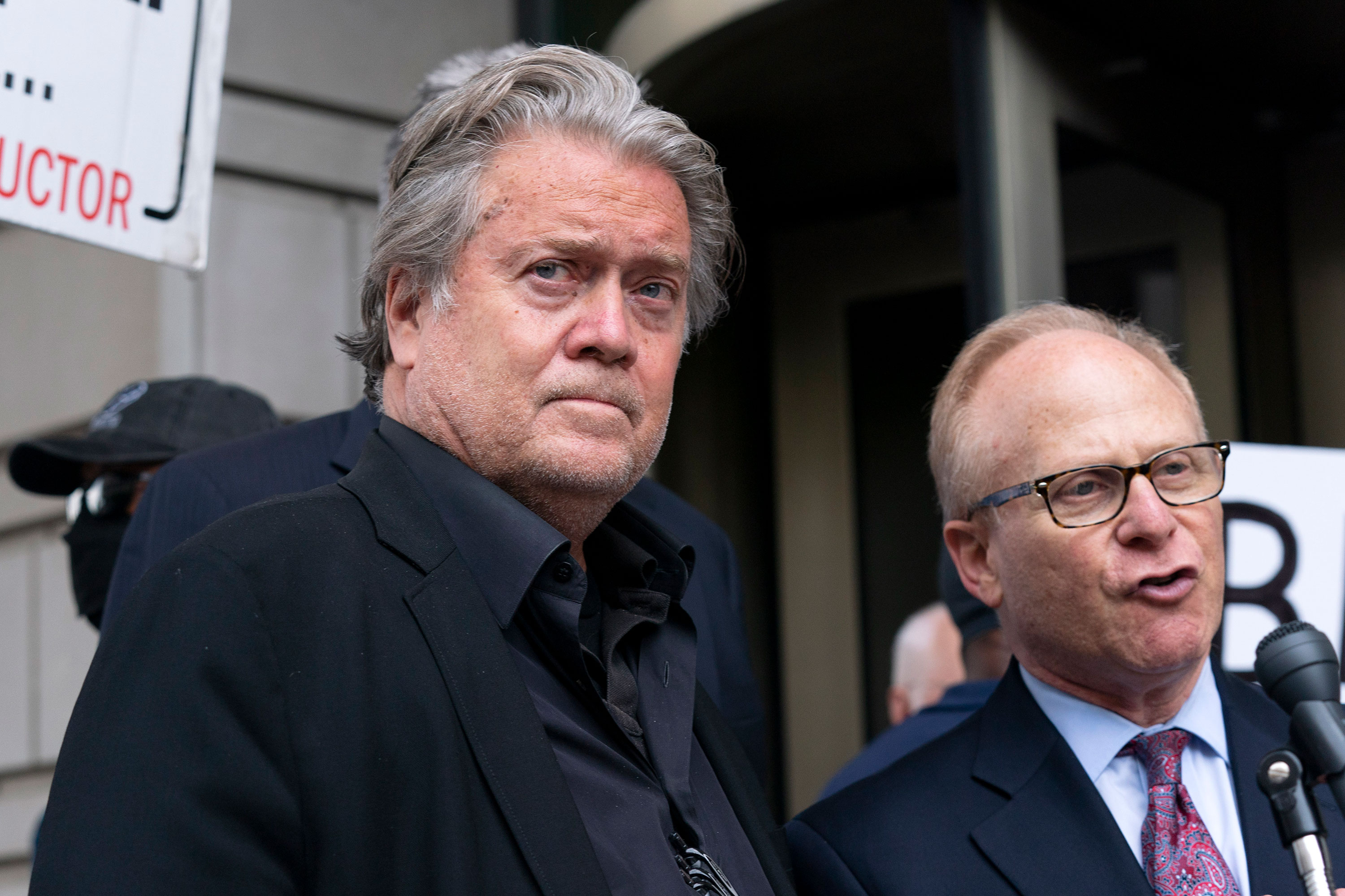 Steve Bannon stands next to his attorney David Schoen as he speaks to the media on Thursday.