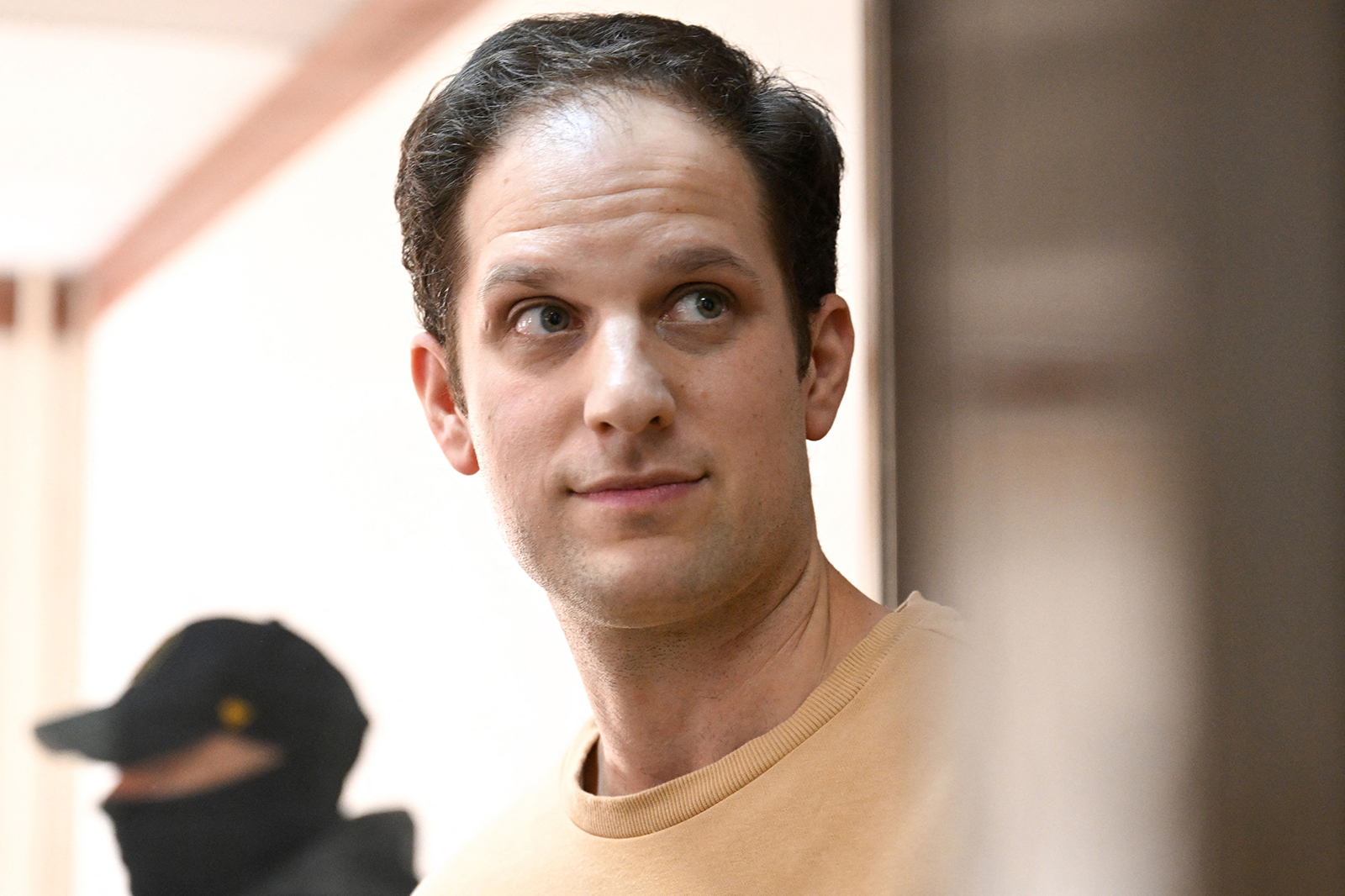 US journalist Evan Gershkovich stands inside a defendants' cage before a hearing in Moscow on September 19.