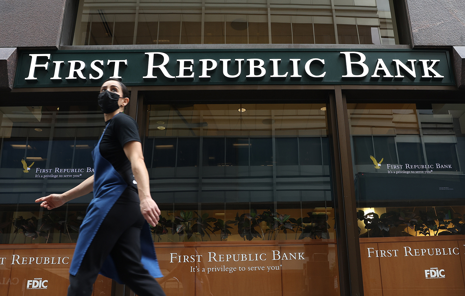 A person walks by the First Republic Bank headquarters on March 13 in San Francisco, California. 