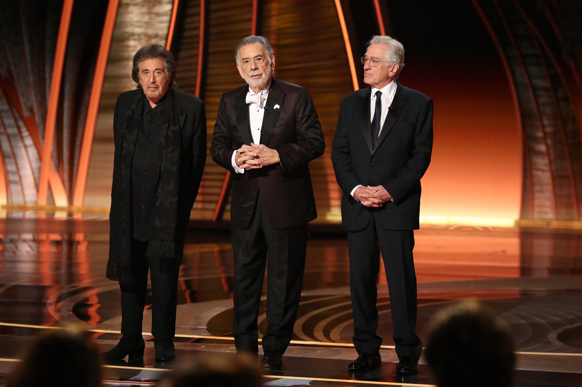 From left: Al Pacino, Francis Ford Coppola, and Robert De Niro speak onstage during the 94th Annual Academy Awards.