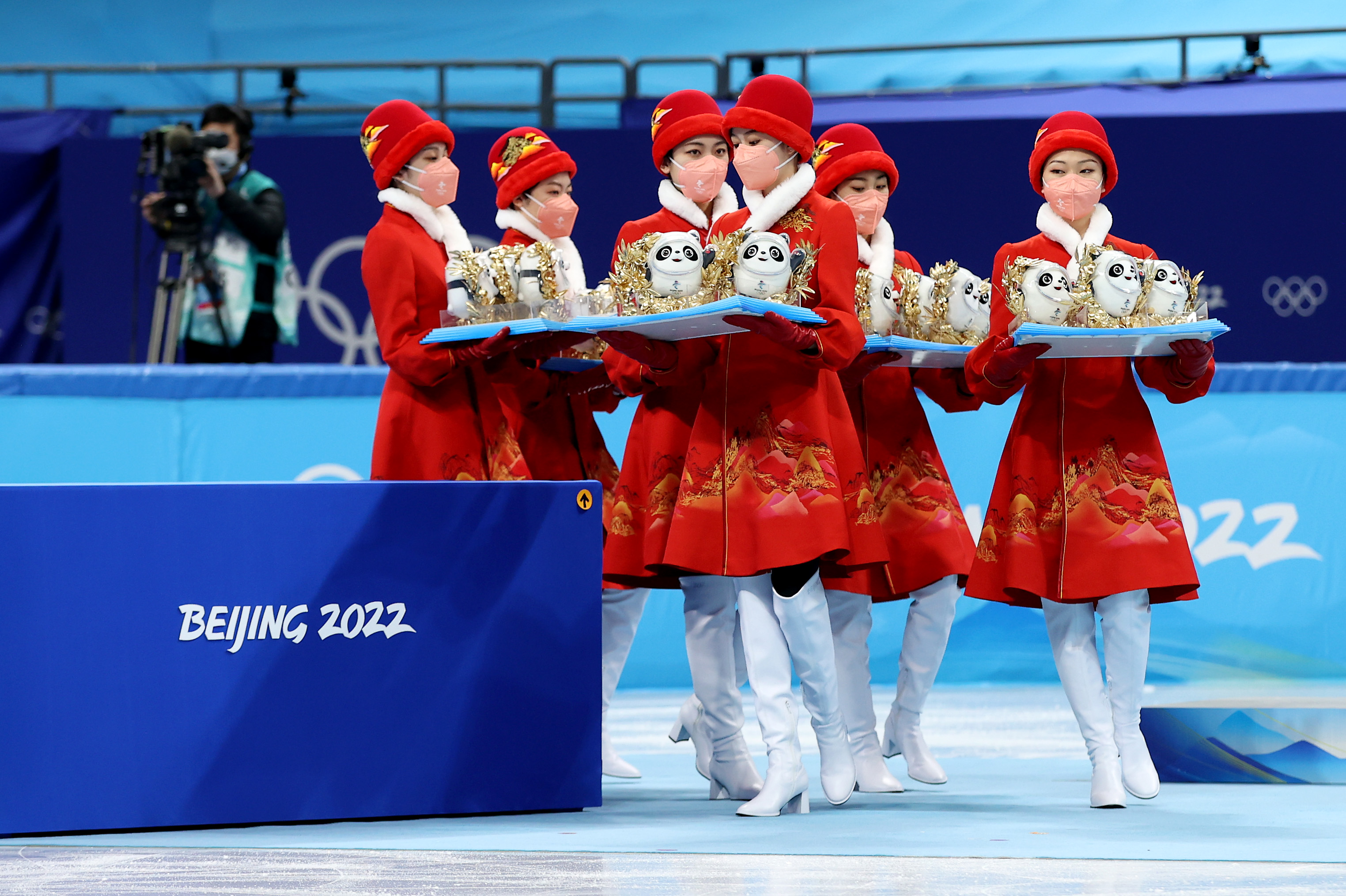 Games staff prepare to give Beijing 2022 mascots to medal winners.