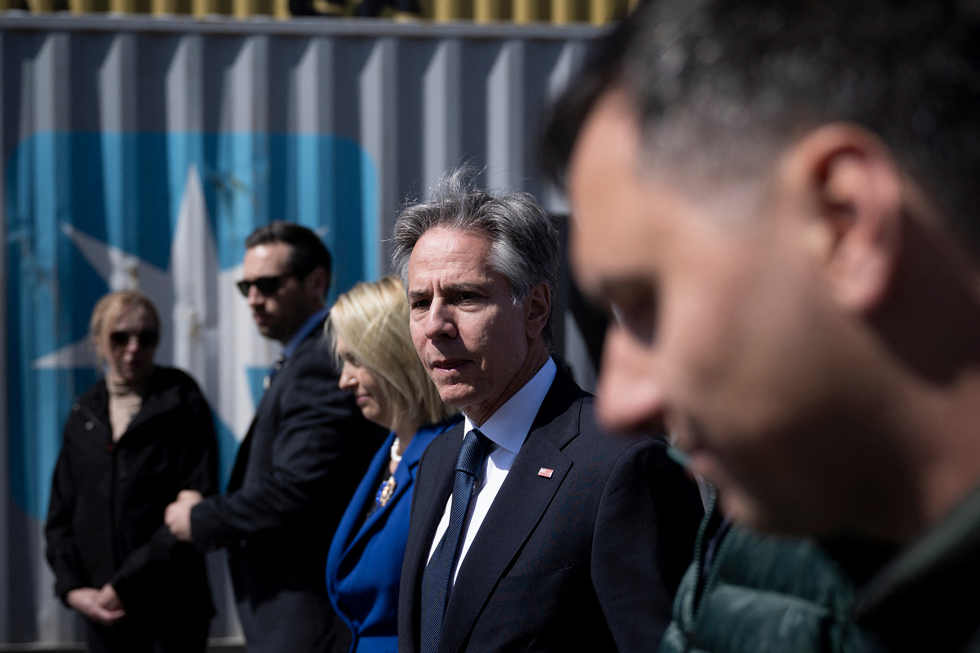 US Secretary of State Antony Blinken (C) leaves after his visit to an agricultural logistics and transshipment facility in Vyshneve, Kyiv region, on May 15. The United States will back Ukraine until the country's security is "guaranteed," US Secretary of State Antony Blinken said in a speech in Kyiv on May 14.