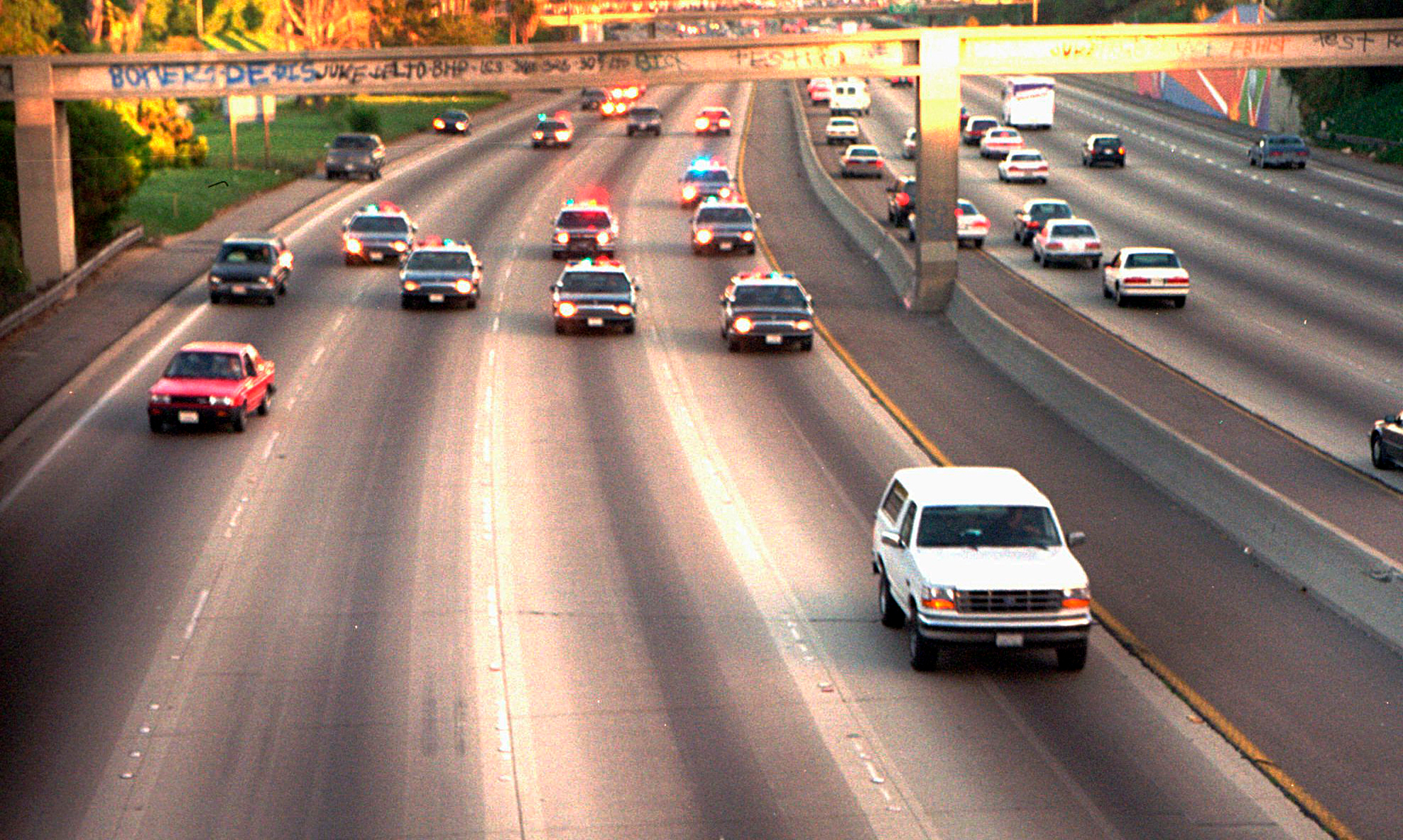 A white Ford Bronco driven by Al Cowlings and carrying O.J. Simpson is trailed by Los Angeles police cars as it travels on a freeway in Los Angeles on June 17, 1994.