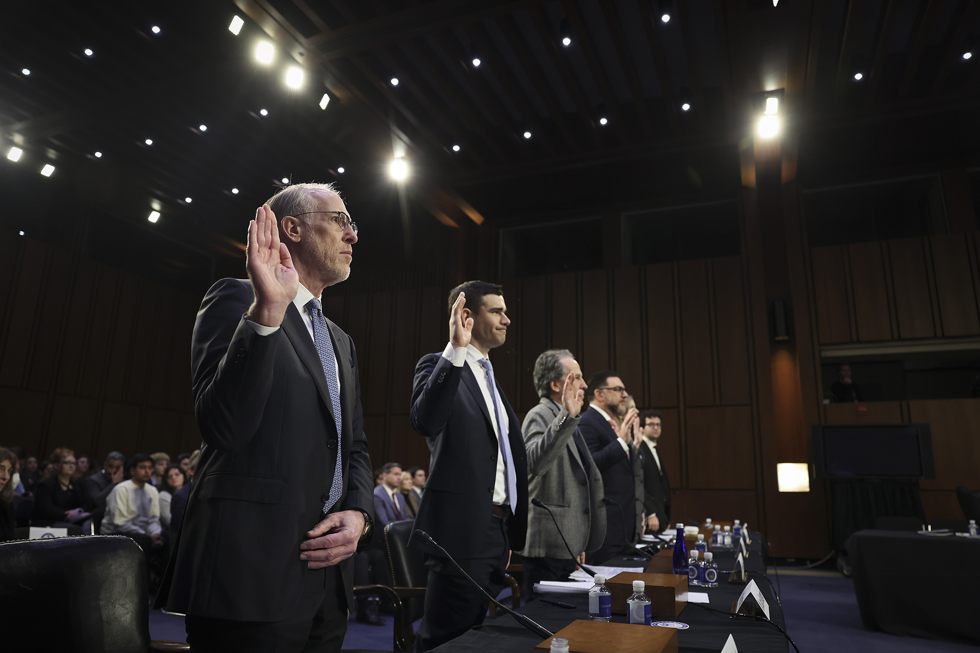 Joe Berchtold (L), president and CFO of Live Nation Entertainment, Inc., and other members of the ticketing and entertainment industry are sworn in before the Senate Judiciary Committee January 24.