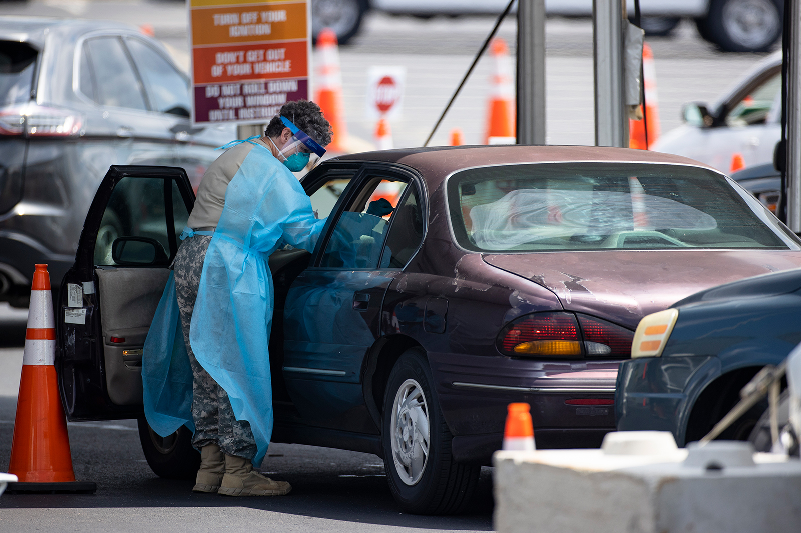 Healthcare workers test people in their car at a Covid-19 testing center outside Nissan Stadium on August 3, in Nashville.
