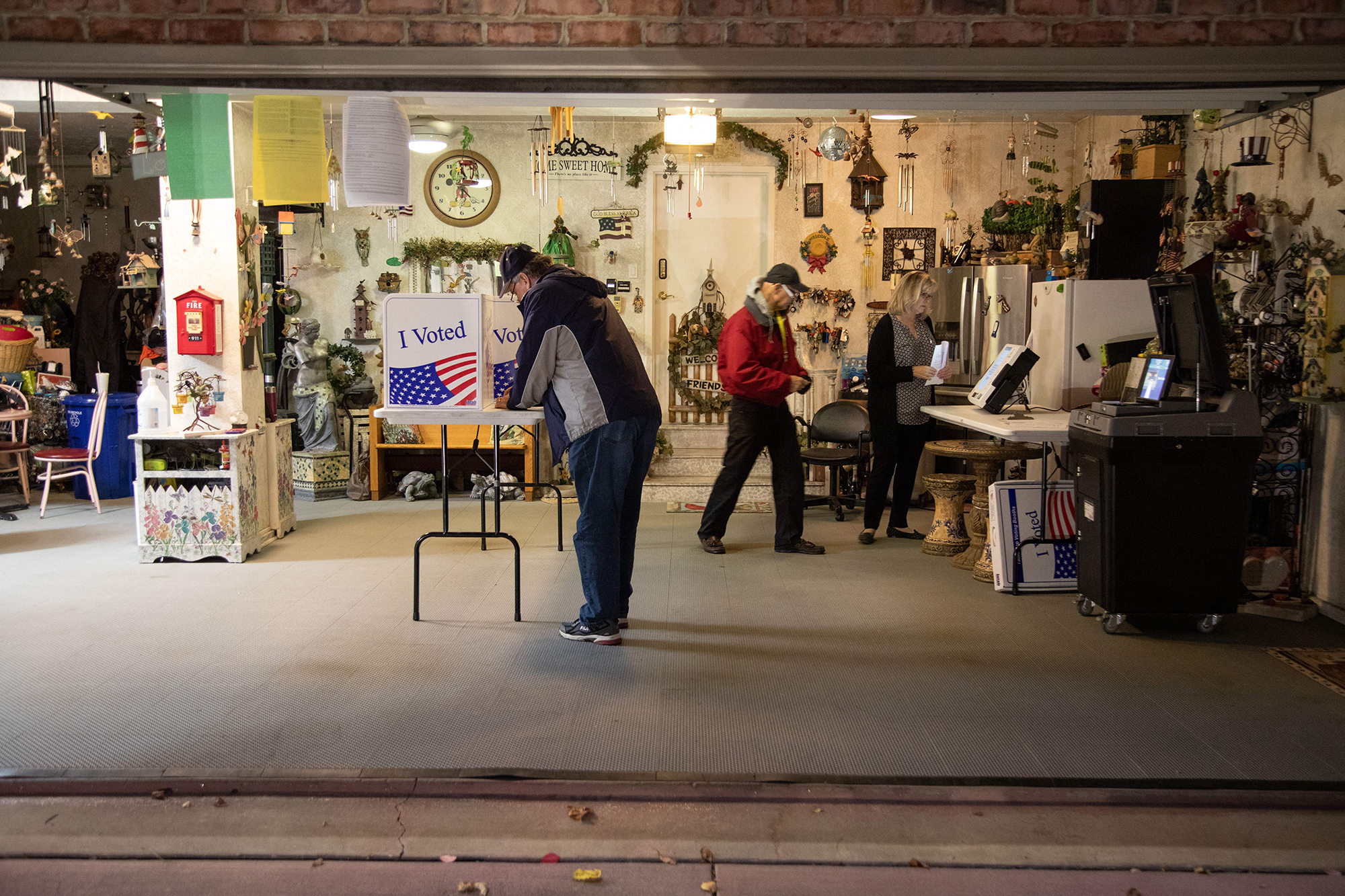 Allegheny County polling coordinator Bob Henrich, left, inspects a polling location in a private resident's garage in Pittsburgh on Tuesday.